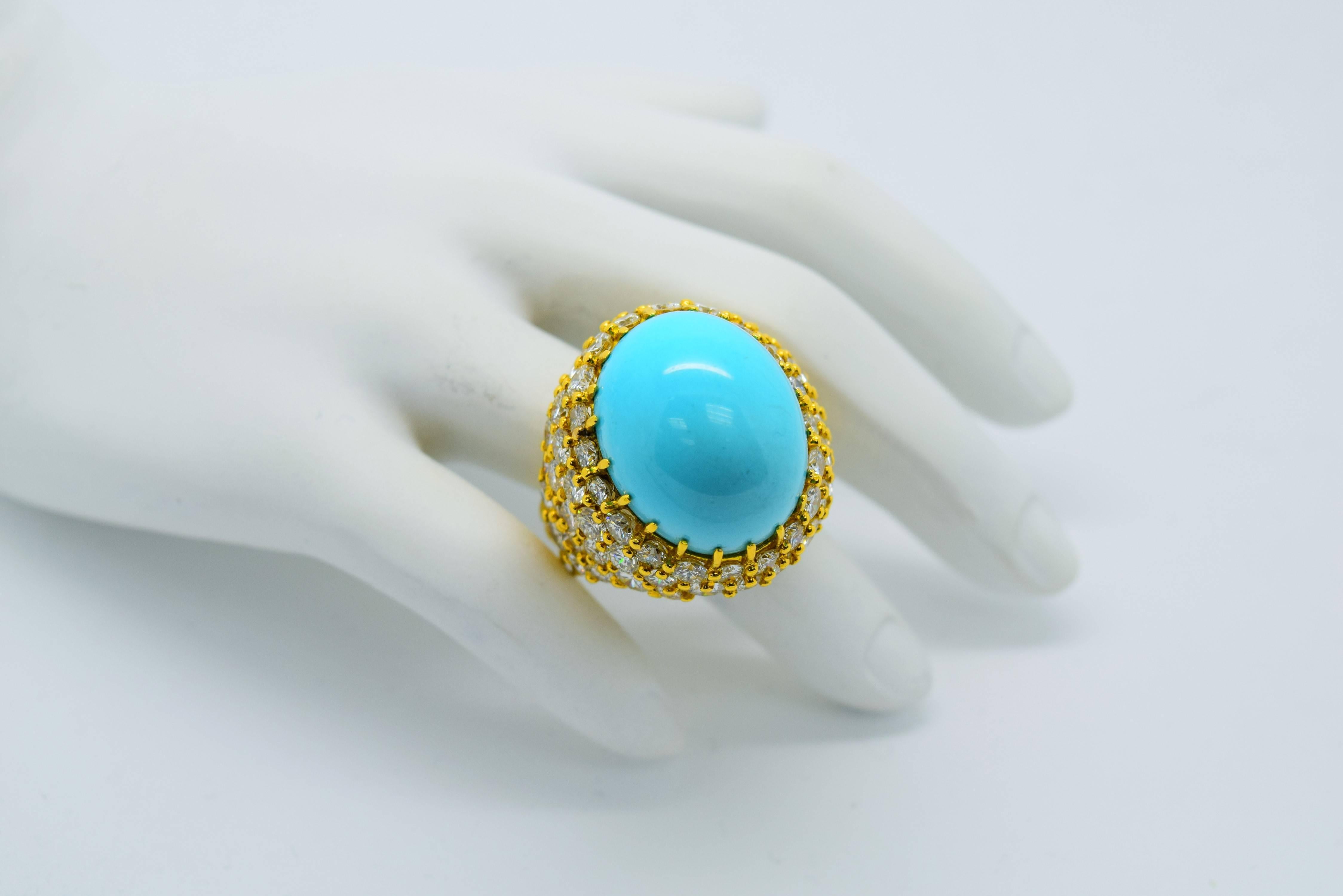 Fine Persian Turquoise and Round Diamond Cocktail Ring set in 18k yellow gold.
Persian Turquoise is approximately 25.02ct and is of fine quality.
The ring is in a beautiful bombe style and has approximately 10.00cttw of 68 fine white and clean