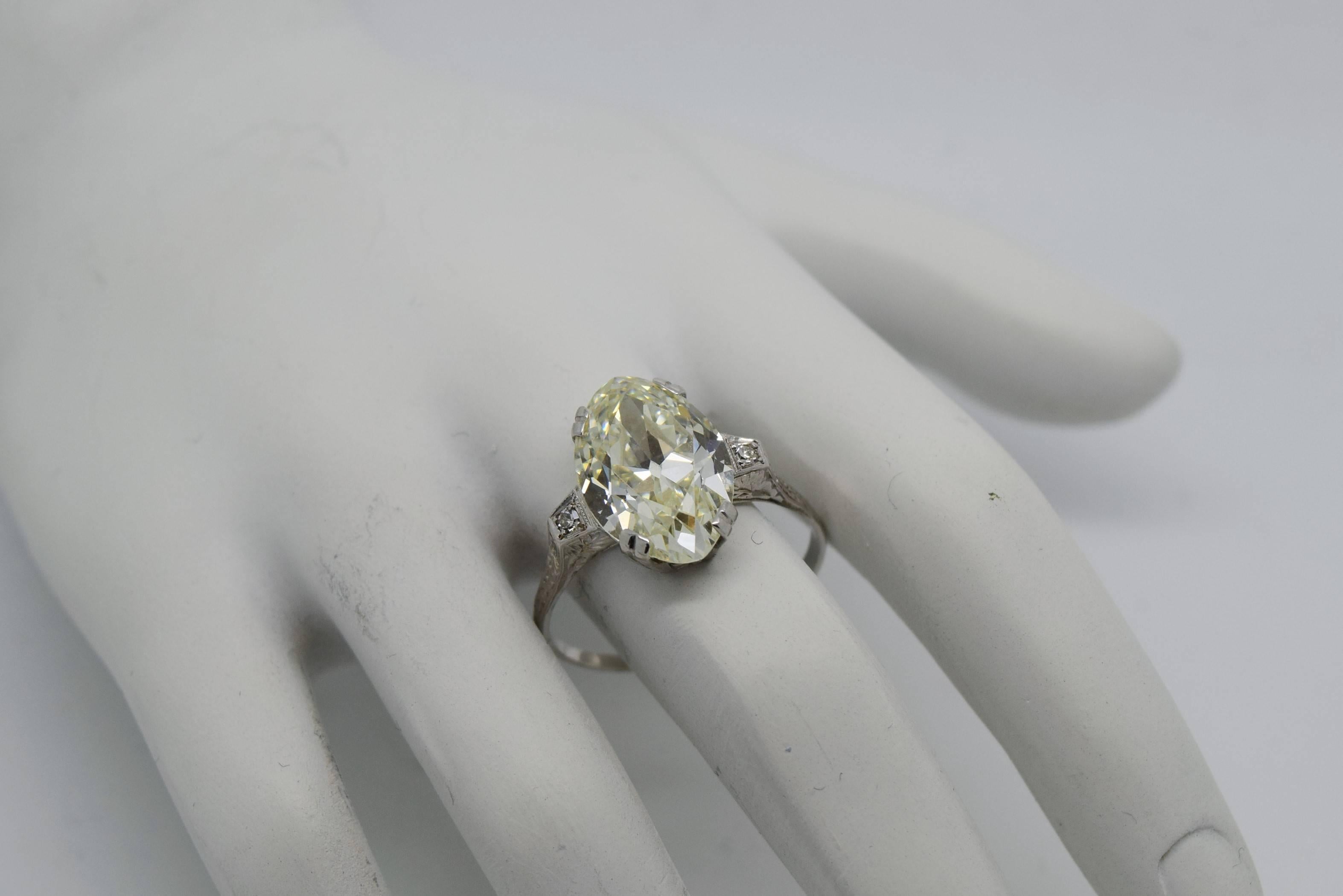 Large and impressive antique engagement ring with a 5.74 carat old cut Marquise diamond, side old cut roound diamonds, set in 18k white gold.
The center diamond is 5.74ct and is approximately N-O in color and VS2 in clarity.
The 2 side diamonds