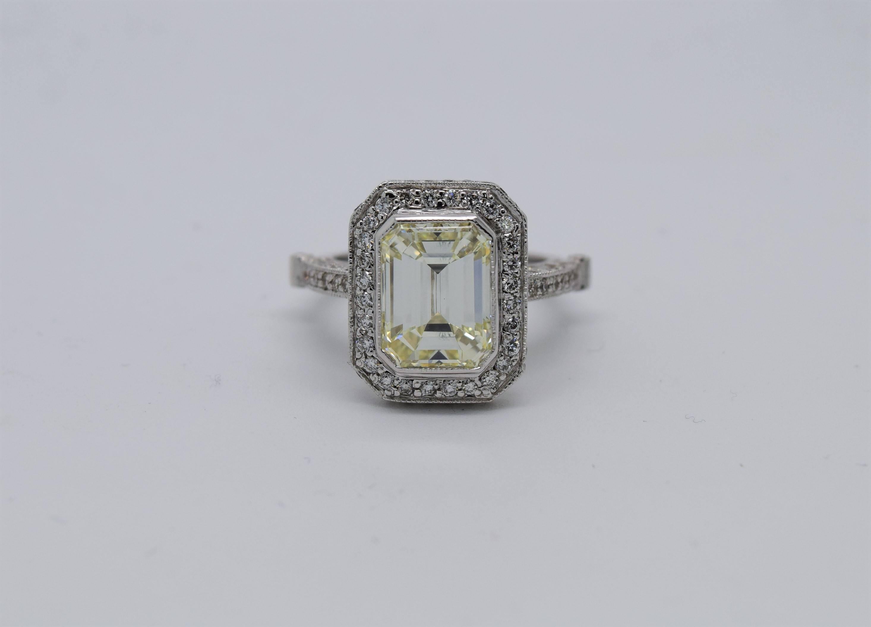 5 carat Emerald Cut diamond cocktail ring set in a custom made 18k white gold ring with side diamonds.

Center diamond weighs 5.06ct and is approximately L-M in color and VS1 clarity.
The ring also has side diamonds set all around and under the