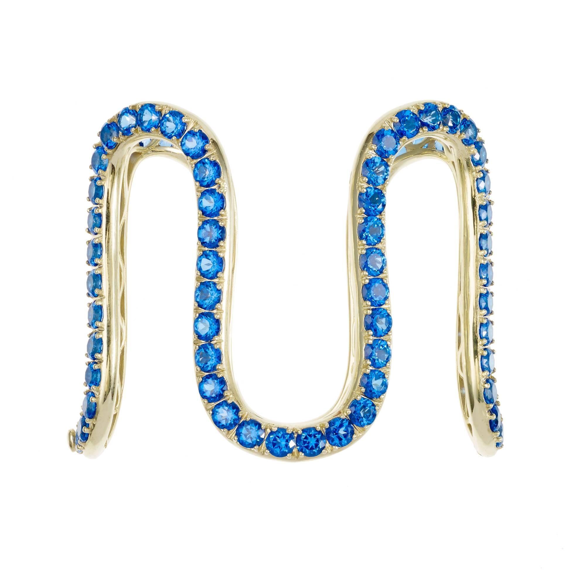 *MADE TO ORDER - 5 WEEK LEAD TIME*

Sabine Getty Wiggly Cuff in 18k yellow gold set with blue topaz

Topaz: 29.58ct

Yellow, pink, green and blue. Four colours inspired by the Memphis Group, the kookiest of Made in Italy designers, for a