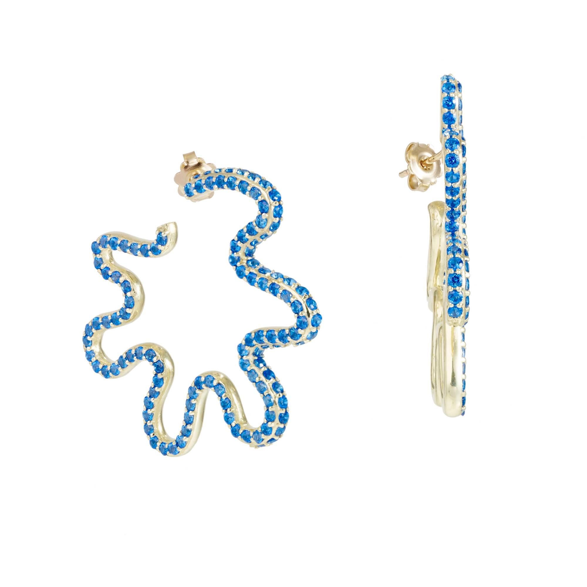 *MADE TO ORDER - 5 WEEK LEAD TIME*

Sabine Getty wiggly hoops earrings in 18k yellow gold set with blue topaz.

Topaz: 9.2ct

Yellow, pink, green and blue. Four colours inspired by the Memphis Group, the
kookiest of Made in Italy designers,