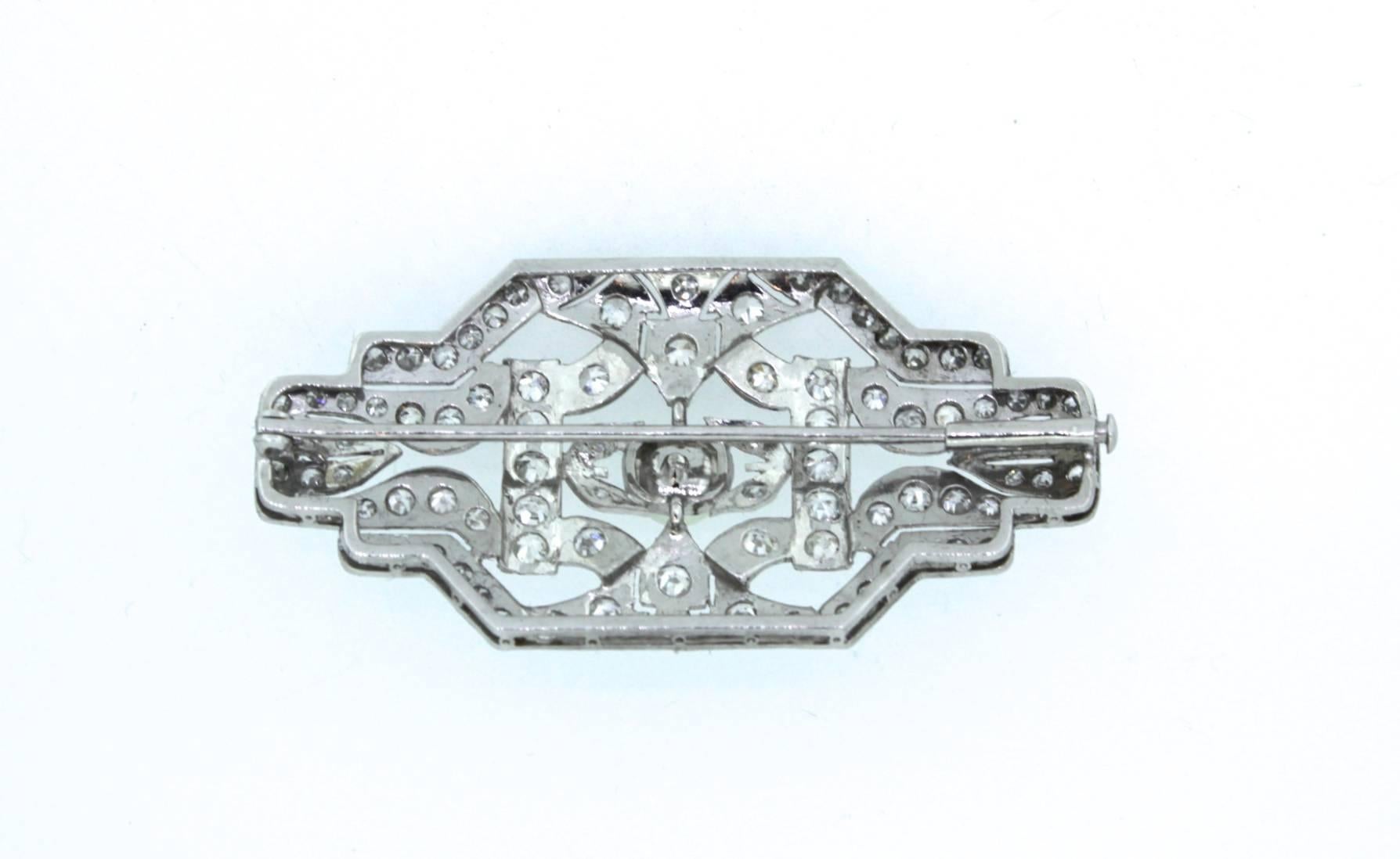 We are offering this antique Art-Deco brooche,

The white golden brooche Is beautifully decorated with diamonds, the amount in carat is over 1.50 carat and at the centre a natural pearl. 
The design is is classical Art Deco style with tight lines