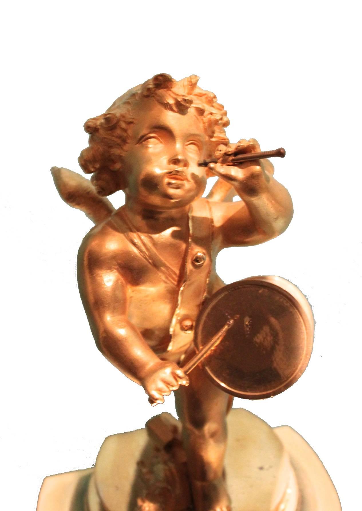 We are offering an wonderful 1st period empire clock.

The empire clock is gilded with gold en portraits a putto playing the tambourine.
The dial is beautifully decorated and made of porcelain, the empire clock is full of details, for example the