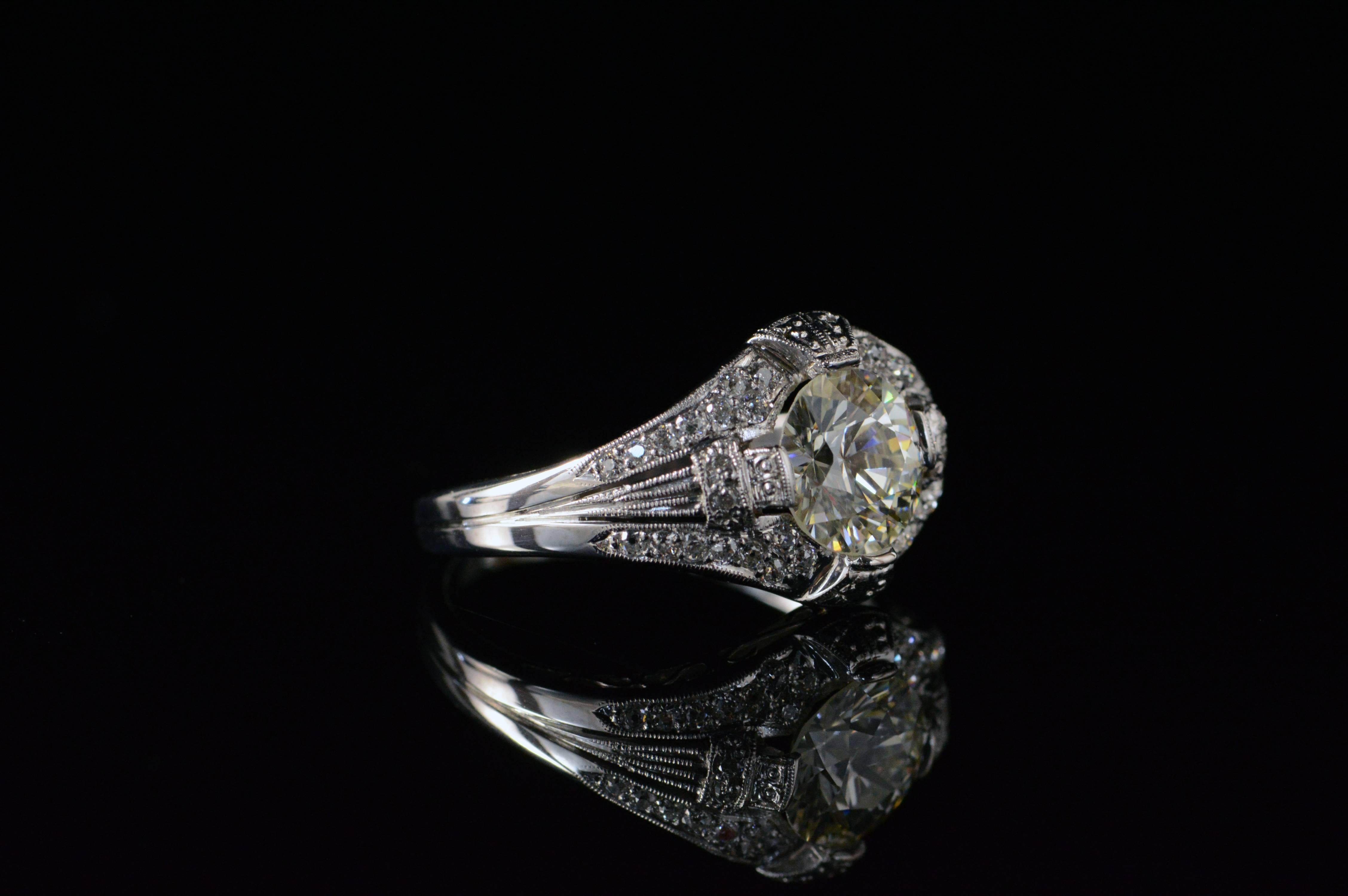 Handcrafted with fantastic detailing and clean lines, this ring is a pristine example of the Art Deco movement. The round brilliant cut diamond that is the center piece of this ring was a fresh invention at the time of this ring’s creation and the