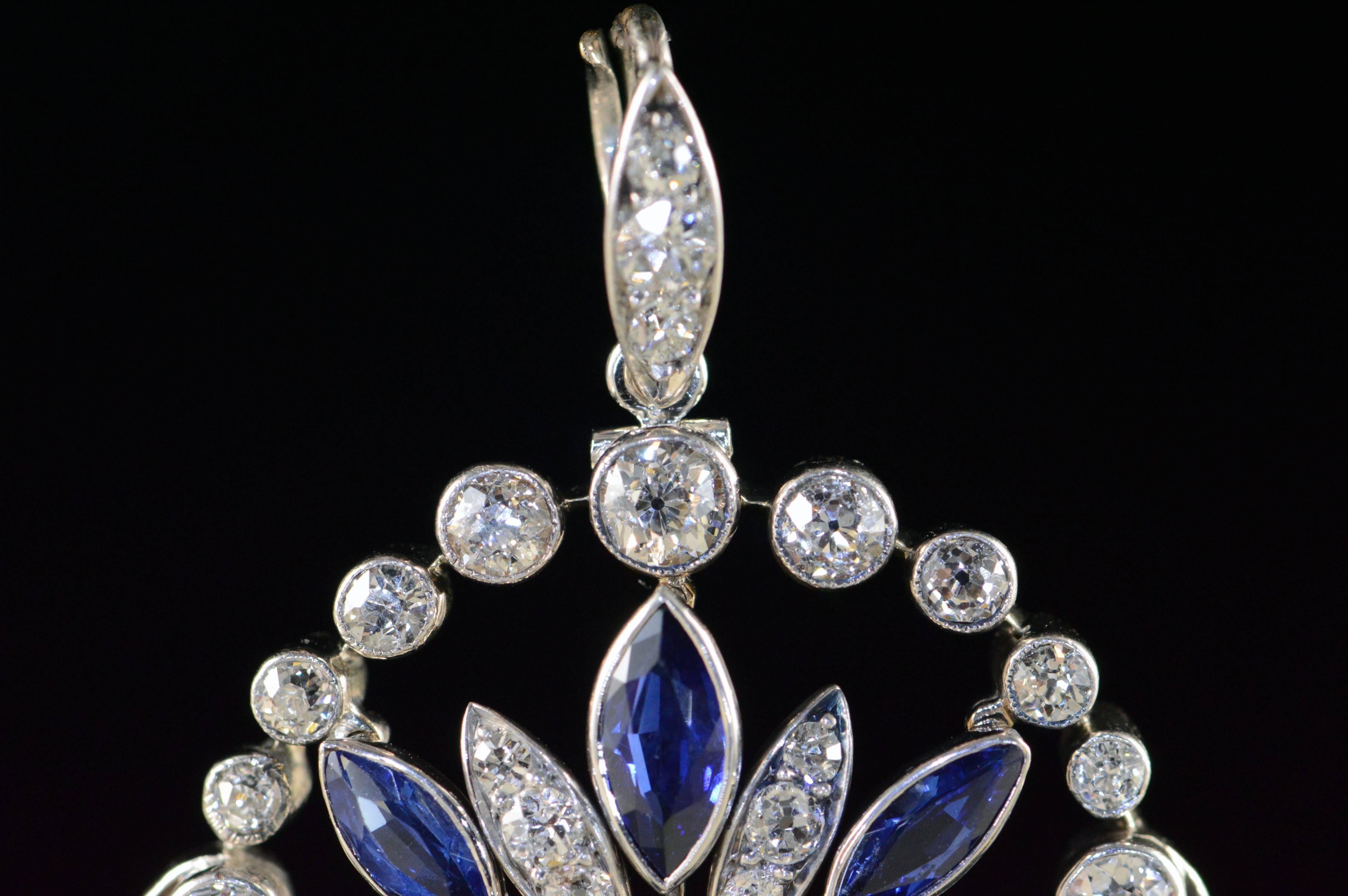 This Art Deco pendant is a wonderful example of the subtle floral motif and styling that influenced the Art Deco and Art Nouveau movement of the 1920’s & 1930’s. It is handcrafted in platinum by period artisans and has a dangle drop Marquise cut