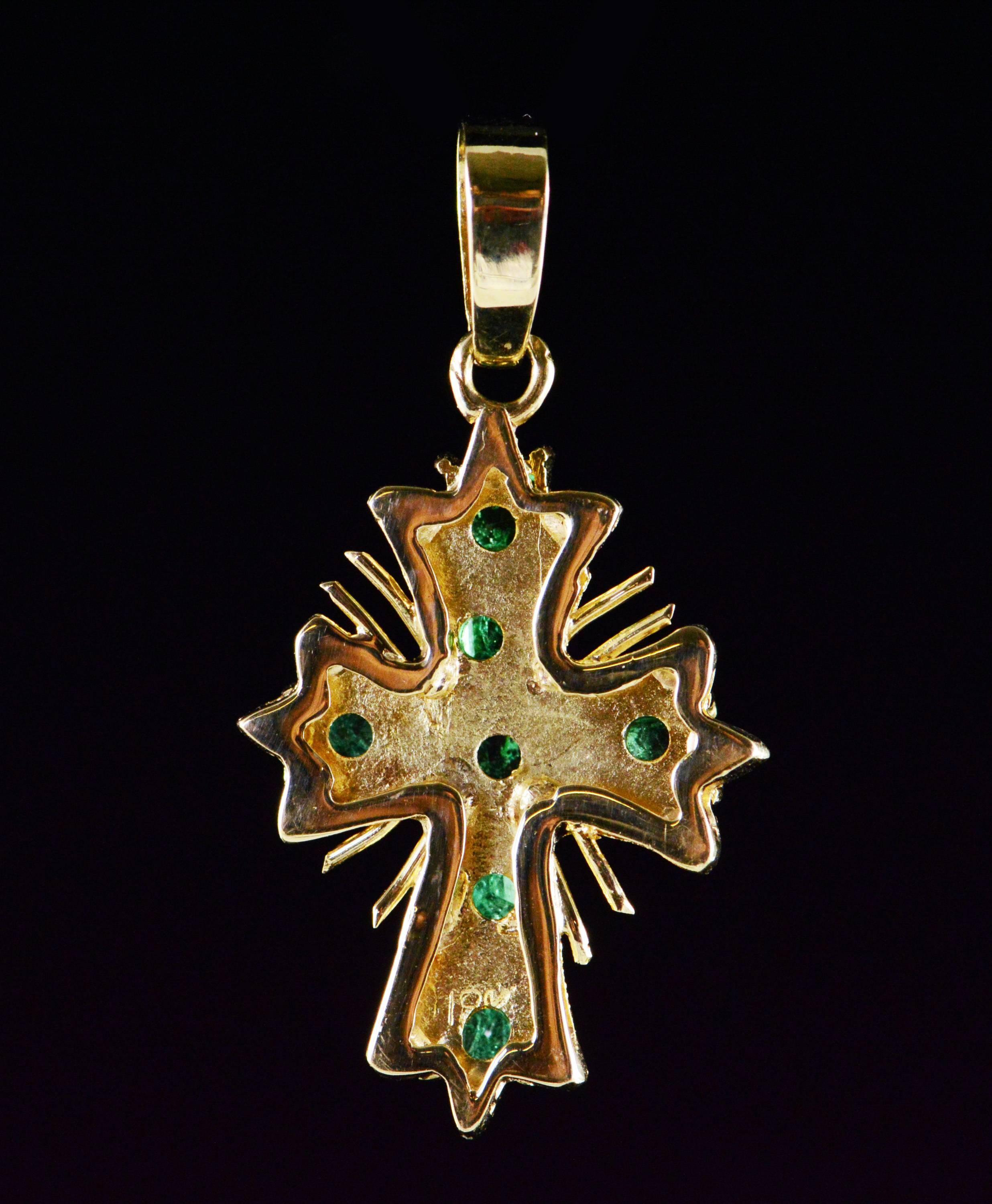 gold cross with emeralds