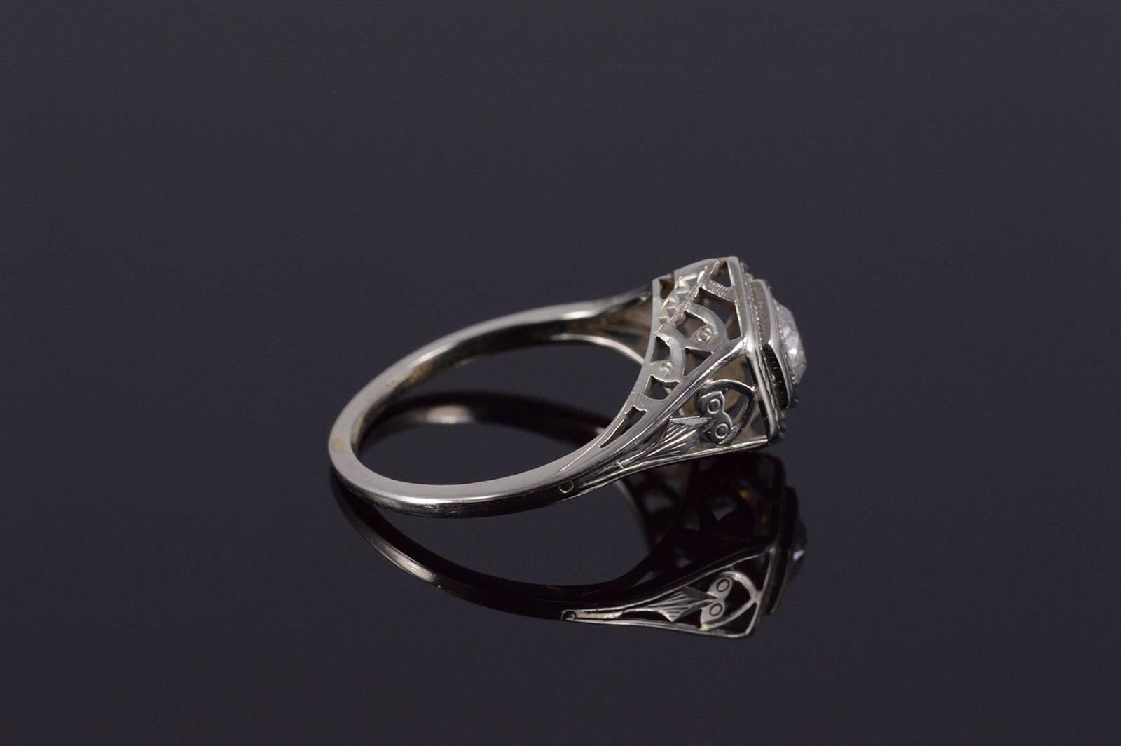 Classic 18K White Gold 0.25 Ct I-J I1 Diamond Center filigree bridge work. Currently a size 6, however it could easily be sized!