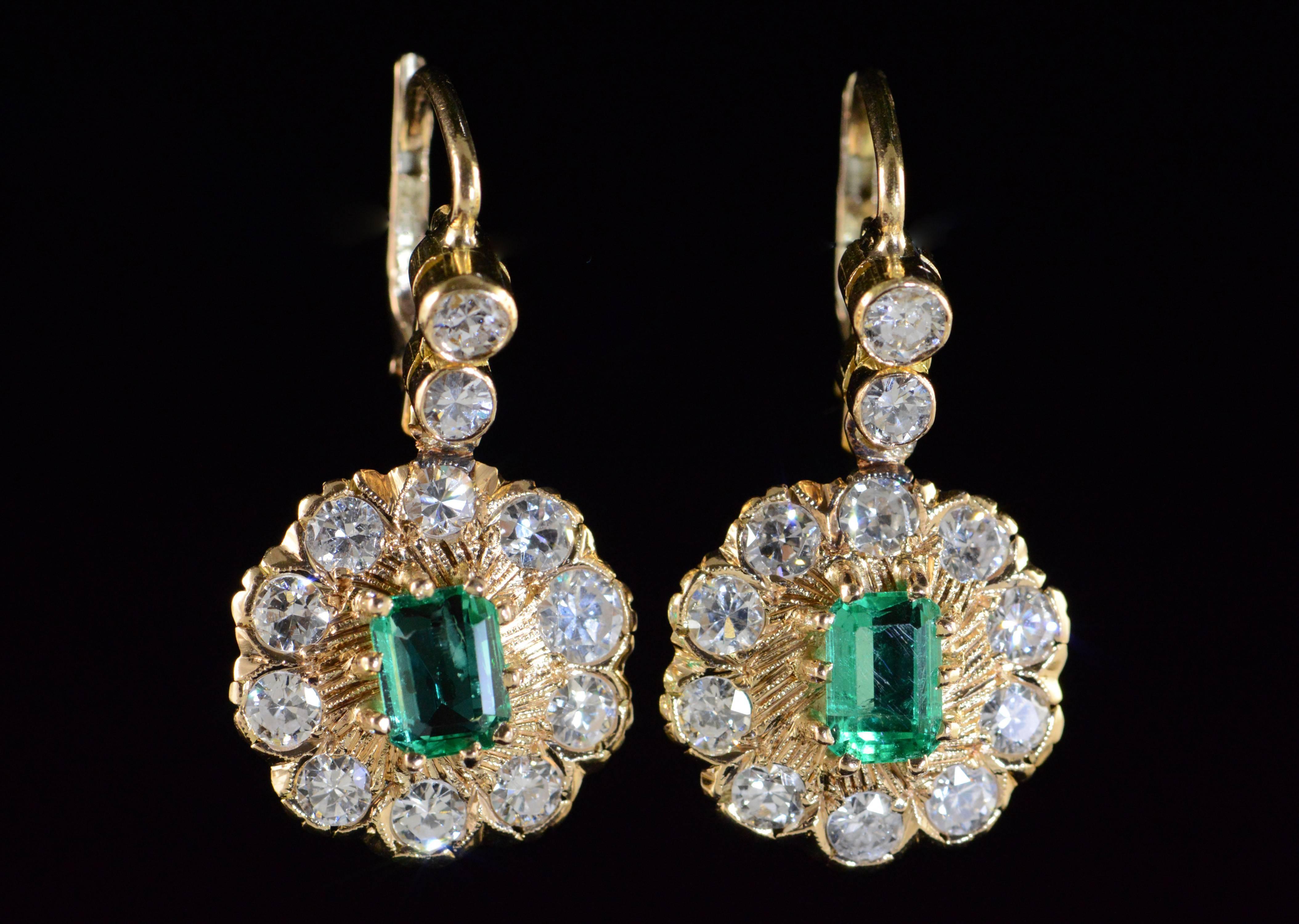 These  drop earrings are set with two beautiful emerald cut emeralds with a brilliant deep green coloration and excellent, even color saturation. The earrings were likely converted to lever backs at a later date for more secure wear and provide a