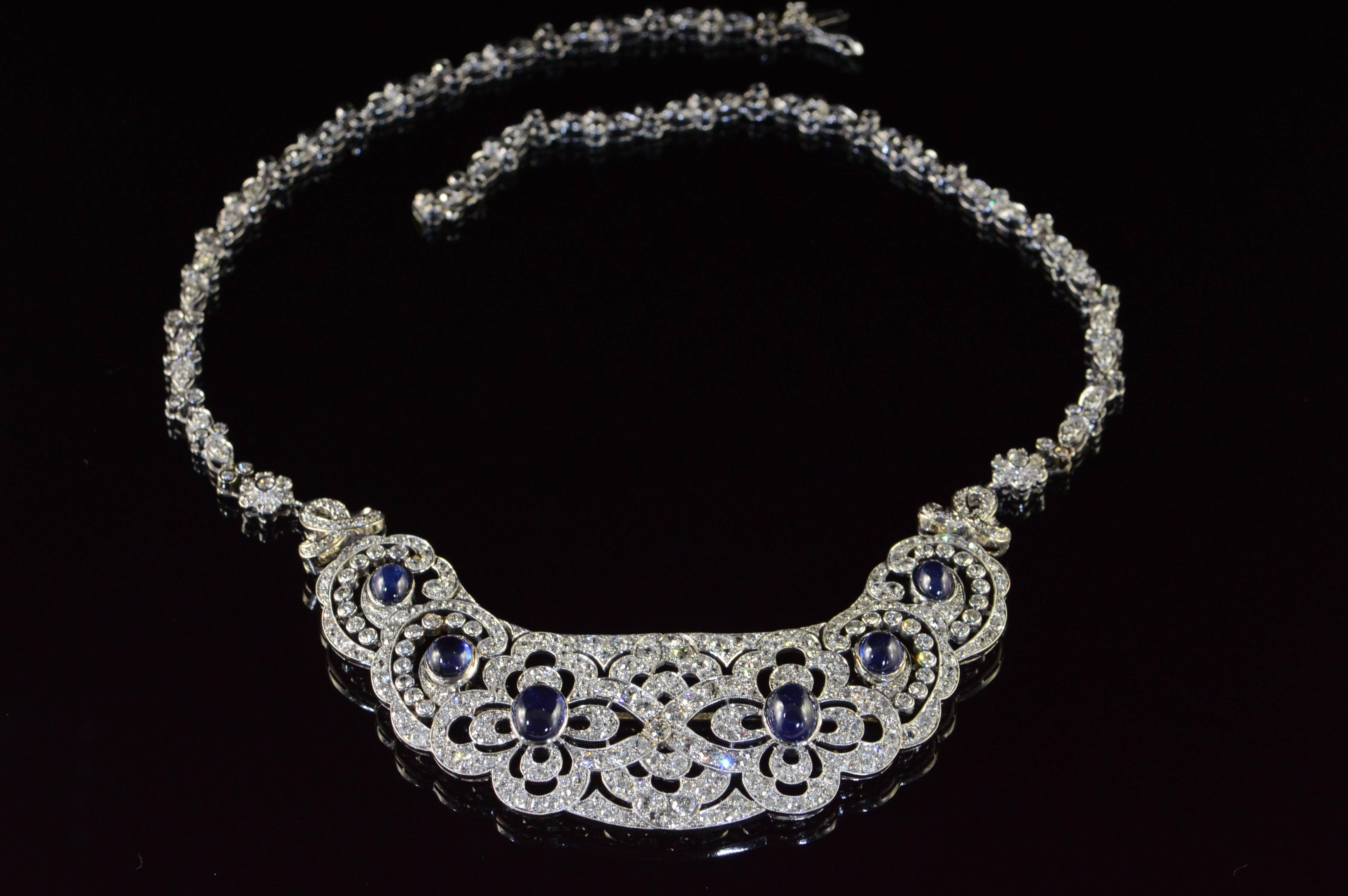 This beautiful “bib” style necklace was most likely a hair comb or hair piece that was at some point was altered by adding a custom styled chain. The base of the necklace is a fantastically styled Art Nouveau platinum piece with cabochon sapphires