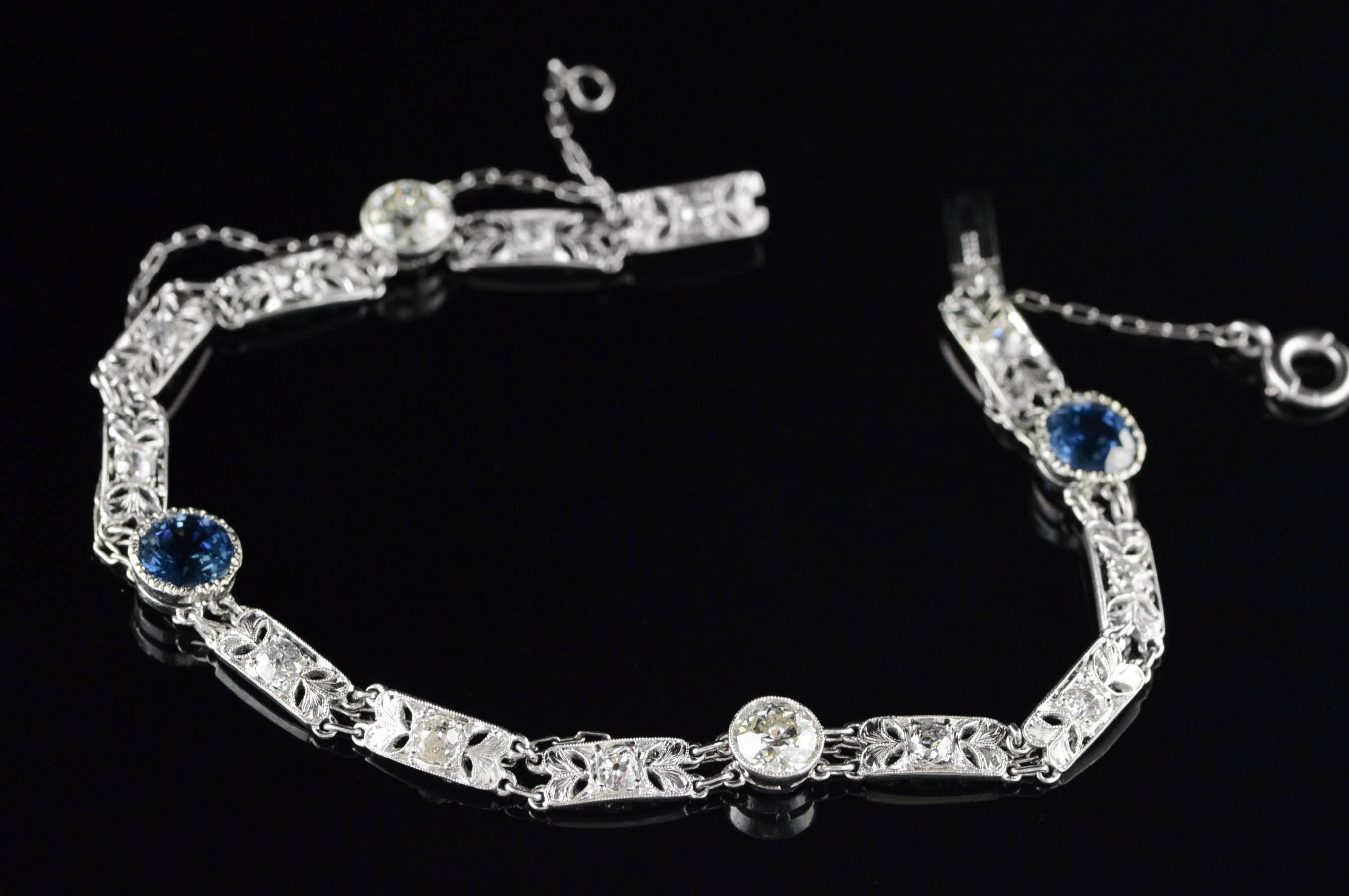  platinum bracelet features two sapphires equaling 2.30 carats and 2 old European cut diamonds equaling 1.30 carats. A safety chain runs the length of the bracelet to maintain its integrity even if a link should be broken.

All diamonds are graded