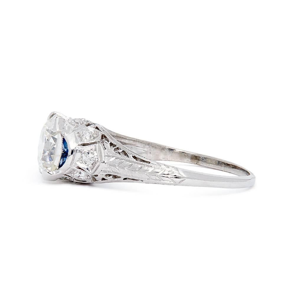 A spectacular art deco period hand engraved diamond and sapphire filigree ring in platinum. Featuring hand formed open filigree work and calibre French cut sapphires, this ring is a wonderful example of an original high quality art deco engagement