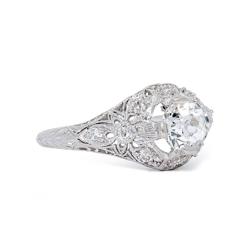 A gorgeous art deco period diamond filigree engagement ring in luxurious platinum. Centered by a spectacular 1.05 carat antique European cut diamond this ring features some of the most elaborate and high quality wire filigree work we've ever