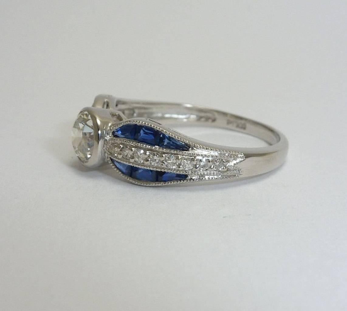 Women's Handmade Sapphire, European Cut Diamond Bow Ring in Platinum For Sale