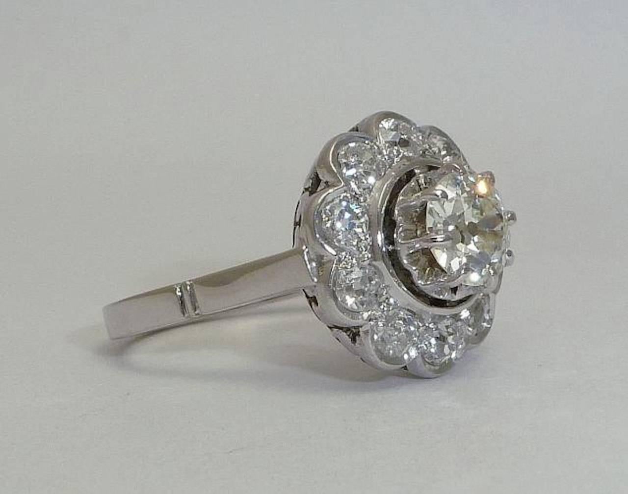 Beacon Hill Jewelers Presents:

A beautiful original art deco period French diamond engagement ring in platinum and 18 karat white gold. Centered by a sparkling high quality old European cut diamond, this ring features a halo of ten beautiful