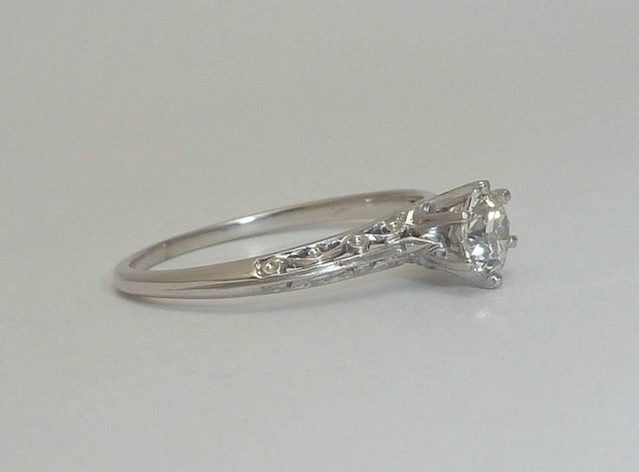 A beautiful original Edwardian period diamond filigree engagement ring in luxurious platinum. Centered by a single old European cut diamond this ring features beautiful scroll filigree work throughout in a hand crafted platinum mounting.

Grading as