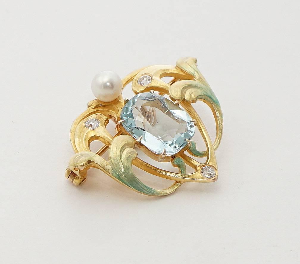 Beacon Hill Jewelers Presents:

A stunning art nouveau period diamond, aquamarine, and enamel pendant made by Krementz. Featuring a cushion shaped aquamarine of approximately 4.50 carats, this pendant features beautiful enameled leaves and bezel