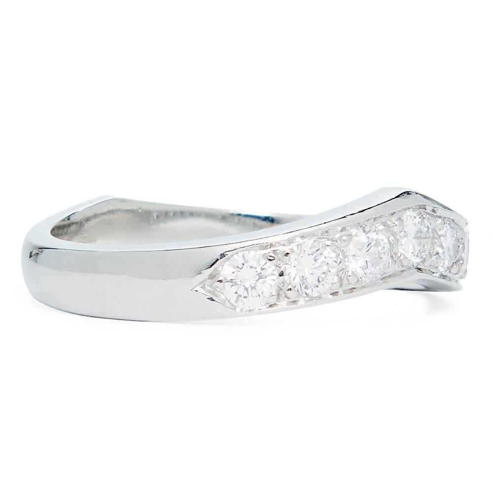 Beacon Hill Jewelers Presents:

A vintage 1950's Tiffany & Company diamond wedding band in luxurious platinum. Set with seven round brilliant cut diamonds, this band is contoured for a streamlined effect and to allow it to sit closely to an
