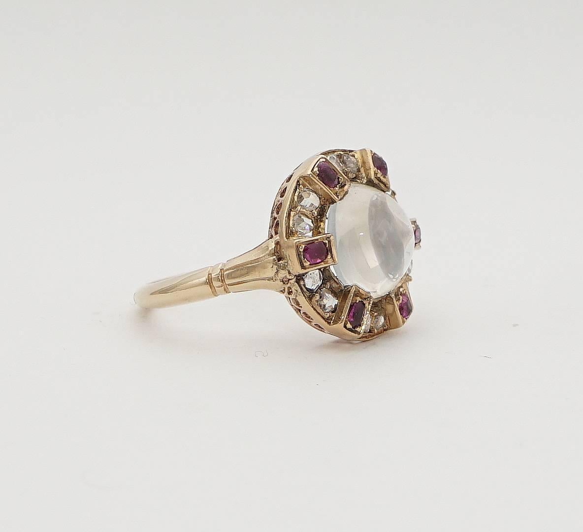 Beacon Hill Jewelers Presents:

A victorian period moonstone, diamond, and ruby ring in luxurious 18 karat yellow gold.  Centered by a beautiful and high quality cabochon cut moonstone this one of a kind ring features a surrounding halo of