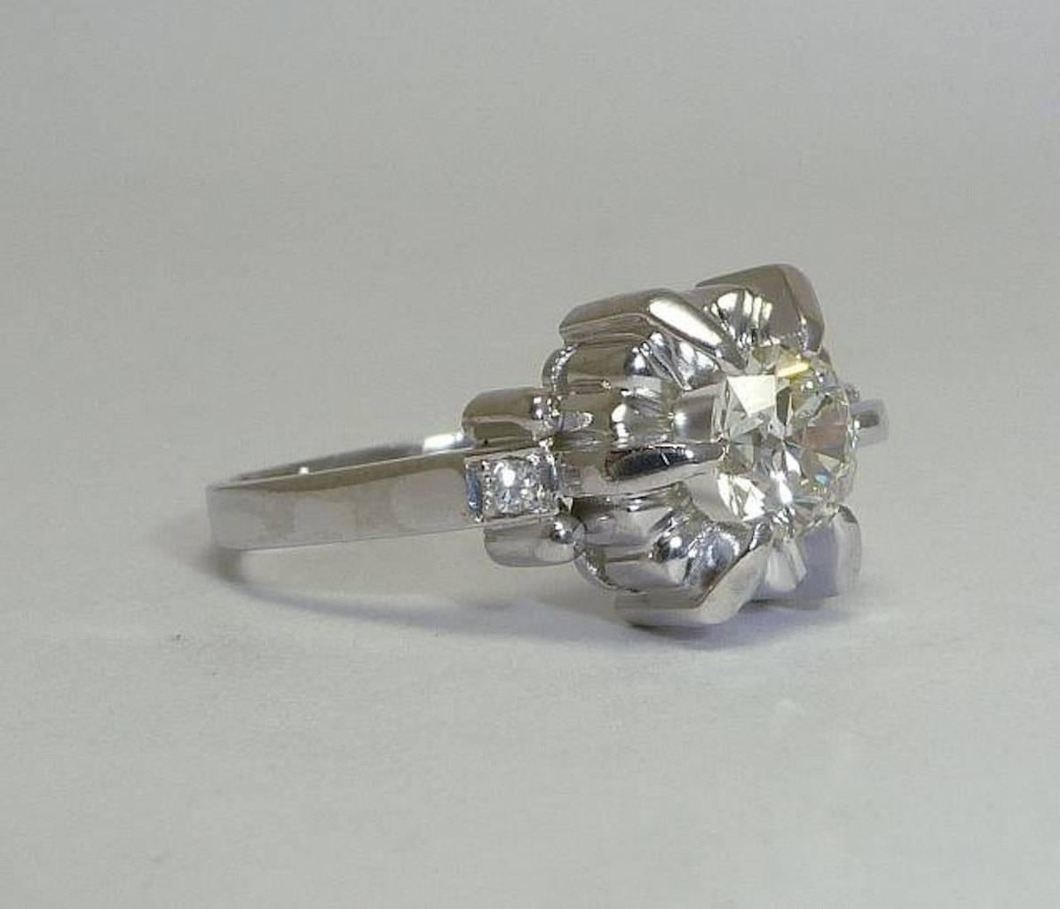 Beacon Hill Jewelers Presents:

A beautiful original art deco period diamond engagement ring in platinum from France. Hand crafted, this sleek art deco ring features a center 0.70 carat old European cut diamond set in a traditional flower style