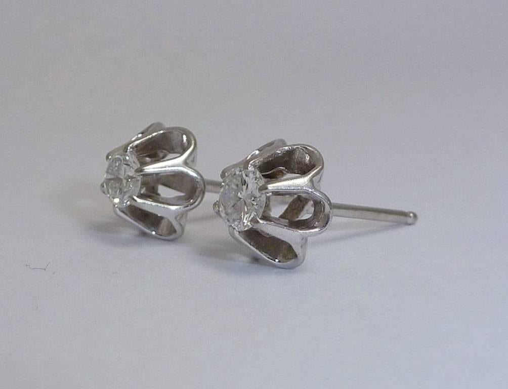 Beacon Hill Jewelers Presents:

A lovely pair of vintage 0.50 carat total weight buttercup style diamond earrings in luxurious platinum. Dating to the 1950's, these lovely vintage earrings are centered by a pair of sparkling round brilliant cut