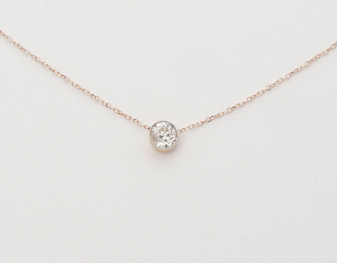 Beacon Hill Jewelers Presents:

An art deco period bezel set European cut diamond solitaire pendant in platinum and rose gold. Set in a bezel of platinum and affixed to a 14 karat rose gold chain this pendant features a sparkling antique European