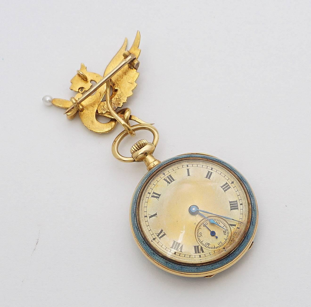 Beacon Hill Jewelers Presents:

A beautiful enameled pendant pocket watch featuring Diamonds, Natural Pearls, and a griffon form brooch from which the pocket watch is suspended. In superb condition, this French made watch is crafted of 18 karat