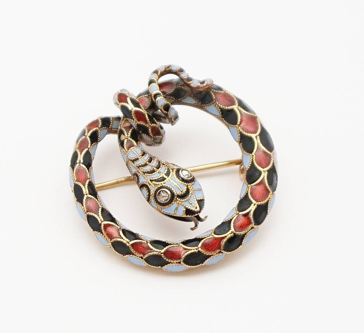 Beacon Hill Jewelers Presents:

A very dramatic, victorian era enameled Snake form brooch in 18 karat yellow gold. Displaying the body of an encircled snake set with diamond eyes, this snake boasts beautiful richly colored red, blue, and black