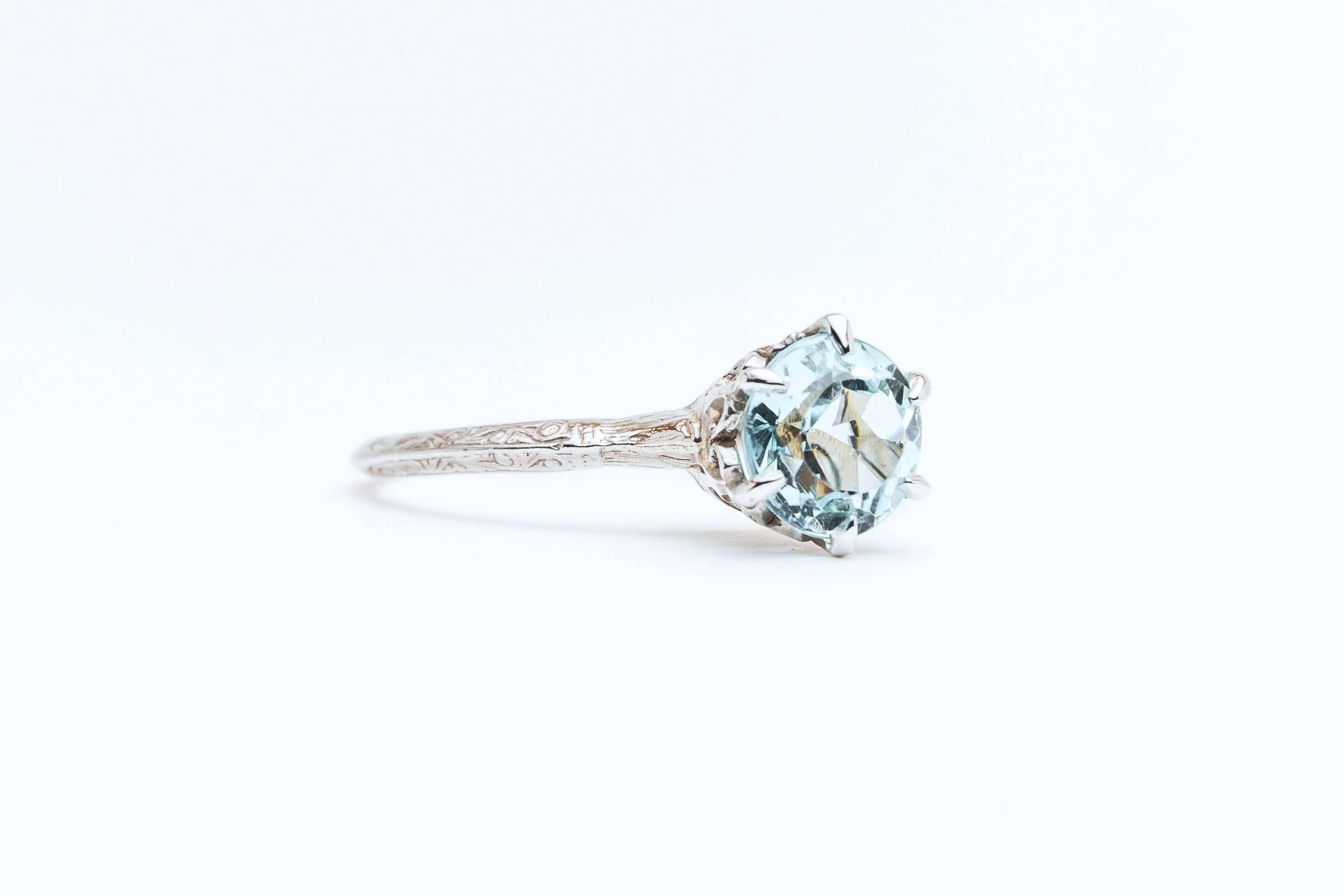 Beacon Hill Jewelers Presents:

A beautiful art deco period aquamarine solitaire ring in 14 karat white gold. Centered by an ocean blue 1.20 carat antique European cut aquamarine this ring features a beautiful hand crafted wire filigree work head,