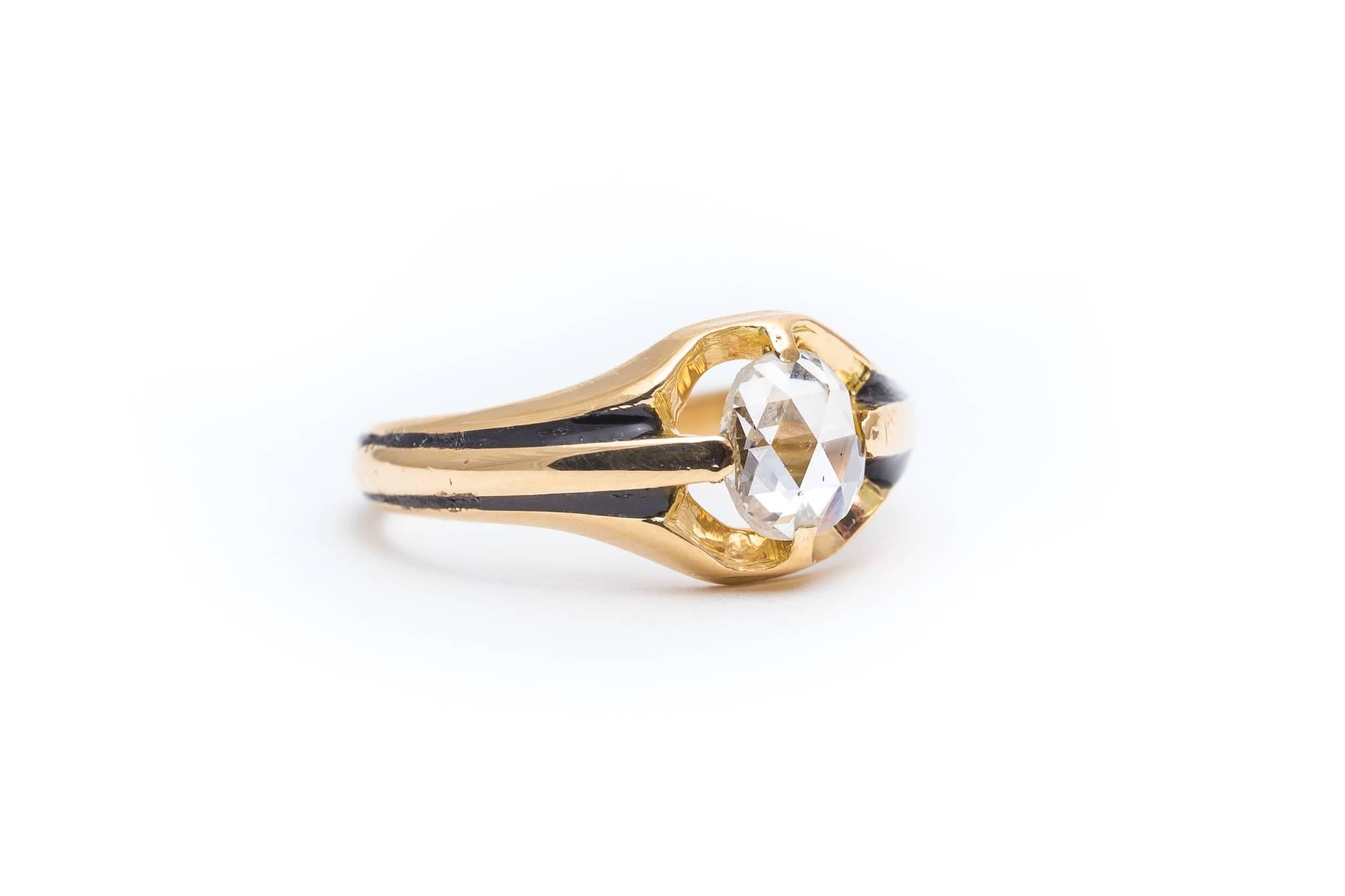 Beacon Hill Jewelers Presents:

An antique original victorian period diamond engagement ring in 18 karat yellow gold. Set with a single antique rose cut diamond, this ring features rich black enamel that complements the bright white diamond