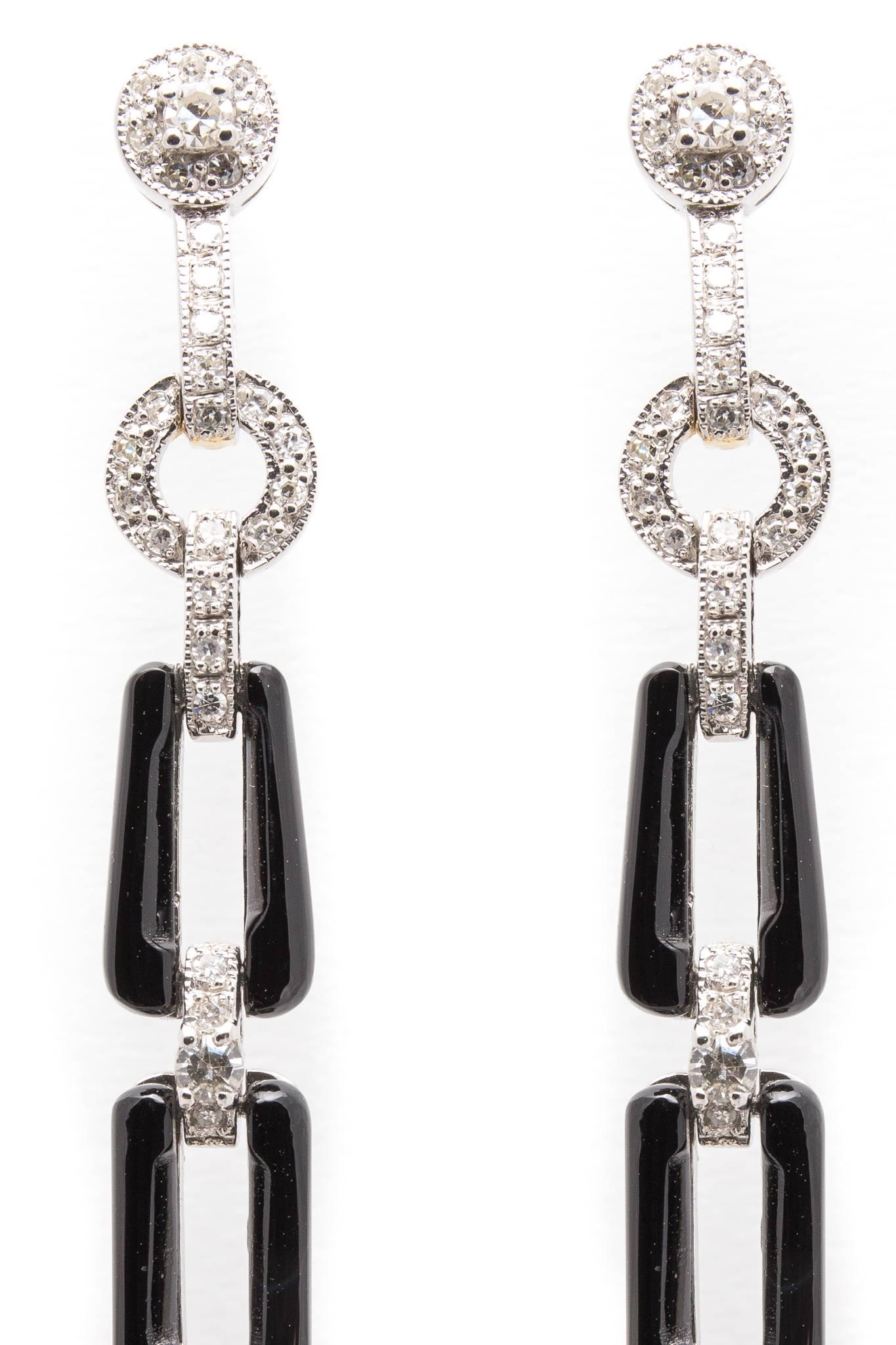 Beacon Hill Jewelers Presents:

A pair of dramatic diamond and onyx earrings in luxurious platinum. Beautifully handcrafted these dangling earrings feature sparkling pave set antique Swiss cut diamonds along with cabochon cut onyx in luxurious