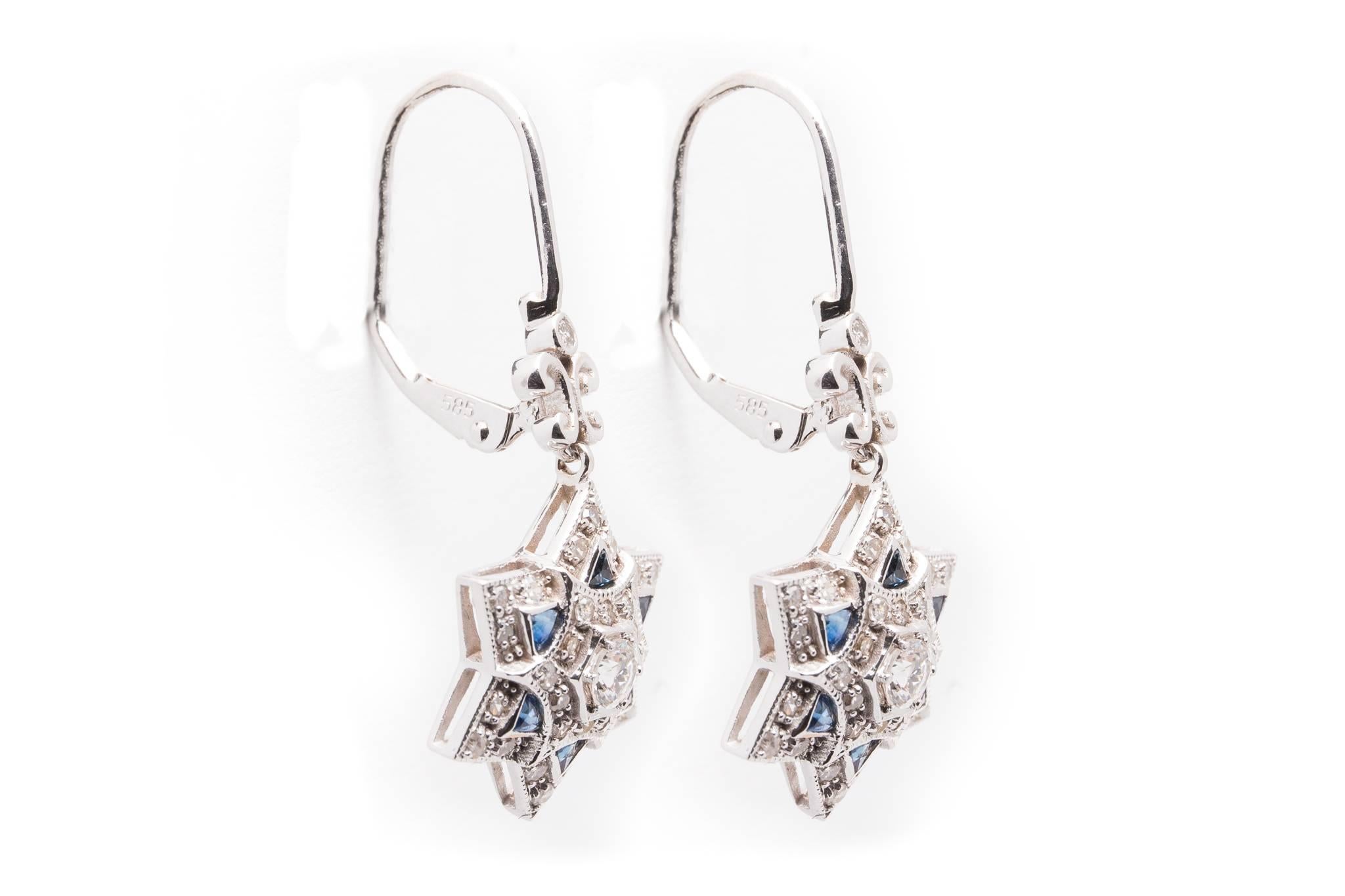 Beacon Hill Jewelers Presents:

A beautiful pair of Star of David shaped earrings in 14 karat white gold. Set with a dozen rich vibrant blue French cut sapphires and pave set with diamonds these are truly stunning and unique earrings.

Centering