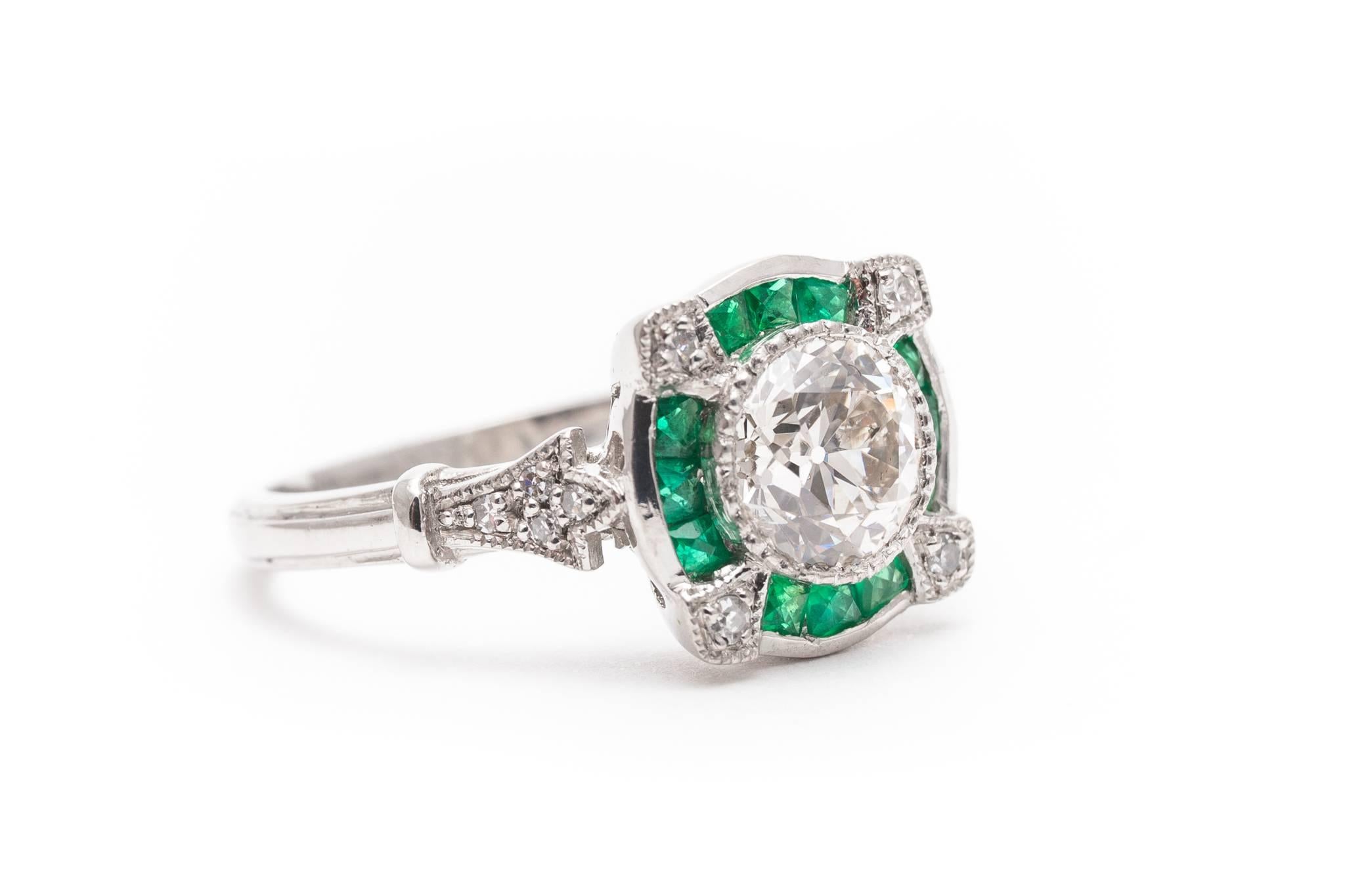A beautiful diamond and emerald engagement ring in luxurious platinum. Centered by a bezel set antique European cut diamond this ring features surrounding French cut emeralds and accenting diamonds in a handmade platinum mounting.

Of beautiful VS2