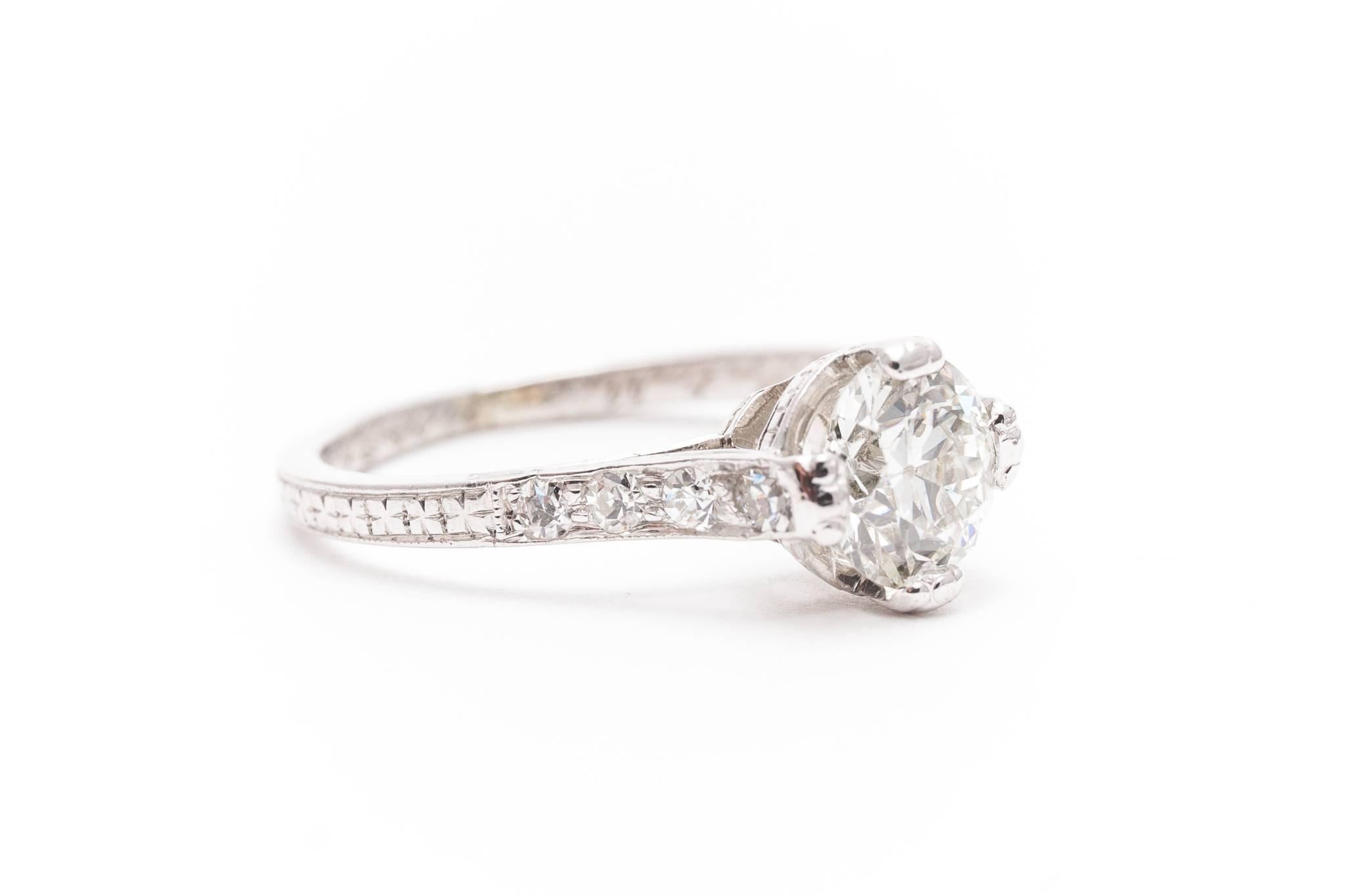 Beacon Hill Jewelers Presents:

A beautiful original art deco period diamond engagement ring in luxurious platinum. Centered by a sparkling 1.02 carat antique European cut diamond this ring features beautiful hand engraving throughout the hand