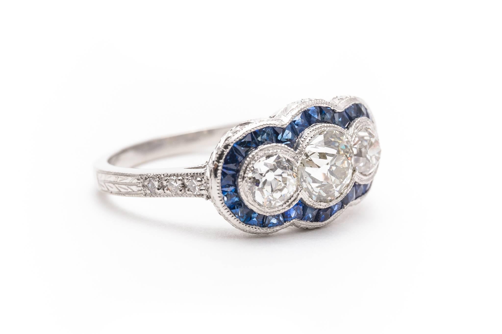 Beacon Hill Jewelers Presents:

A beautiful  sapphire and diamond engagement ring in luxurious hand engraved platinum. Centered by a sparkling antique European cut diamond this ring features fantastic hand engraving and mille grain detailing