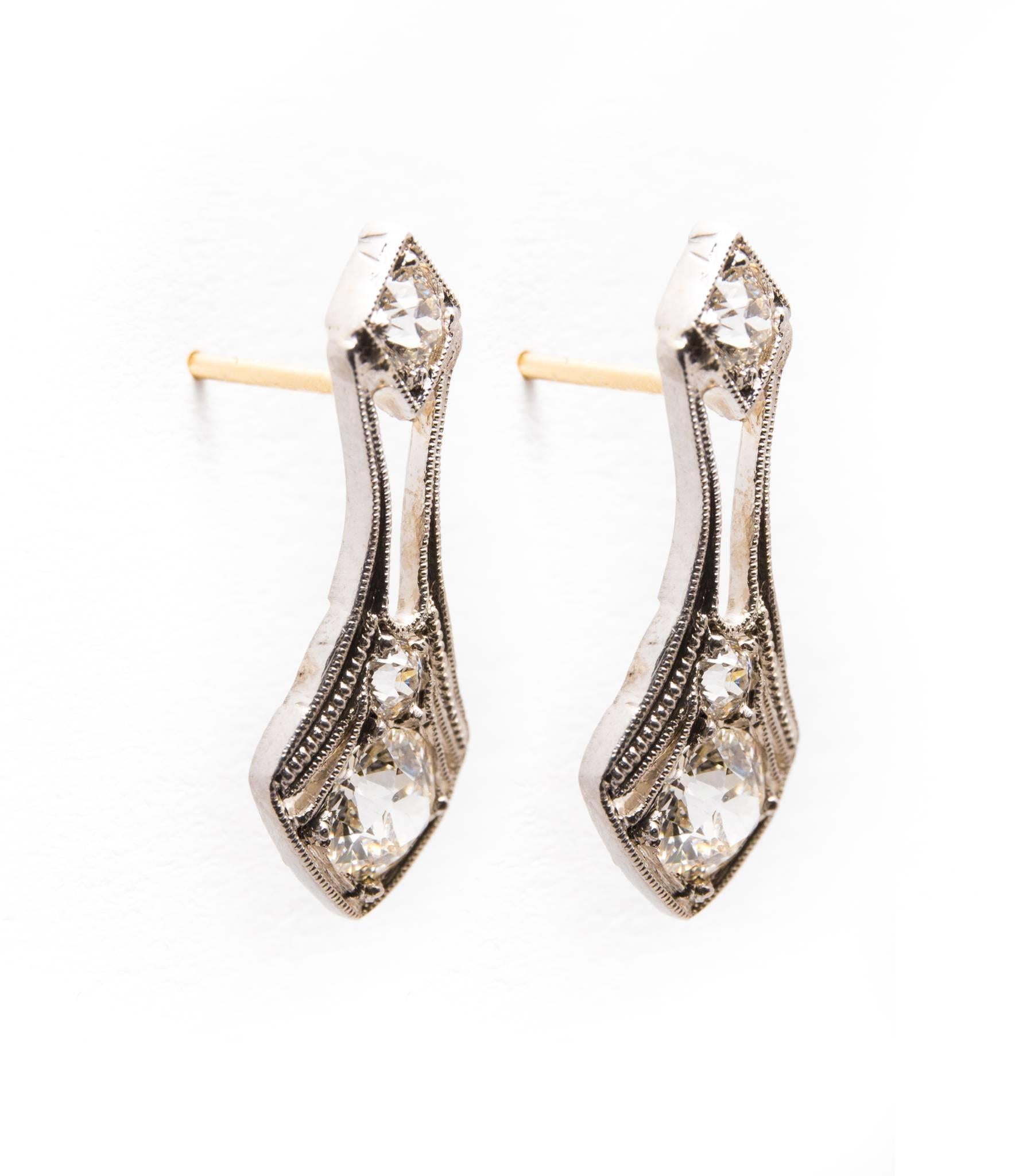 Beacon Hill Jewelers Presents:

A pair of original art deco period diamond earrings in platinum.  Set with a total of six diamonds, these earrings feature beautiful hand crafted platinum mountings with hand applied mille grain beading.

Grading as