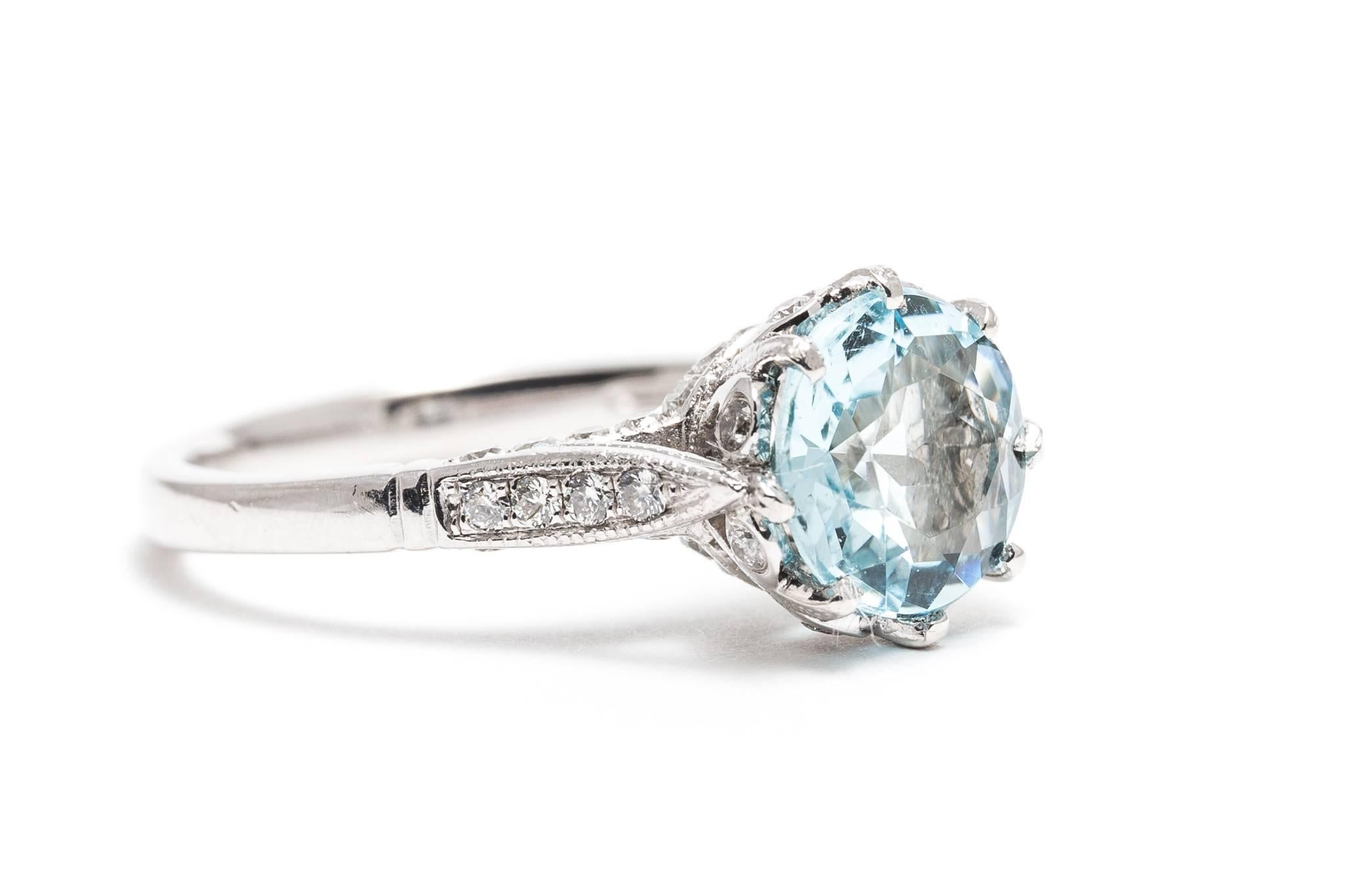 A beautiful aquamarine and diamond ring in luxurious platinum.  Centered by a beautiful vivid ocean blue aquamarine weighing 2 carats, this ring features a beautifully hand crafted and diamond set mounting in luxurious platinum.  

Of superb VVS
