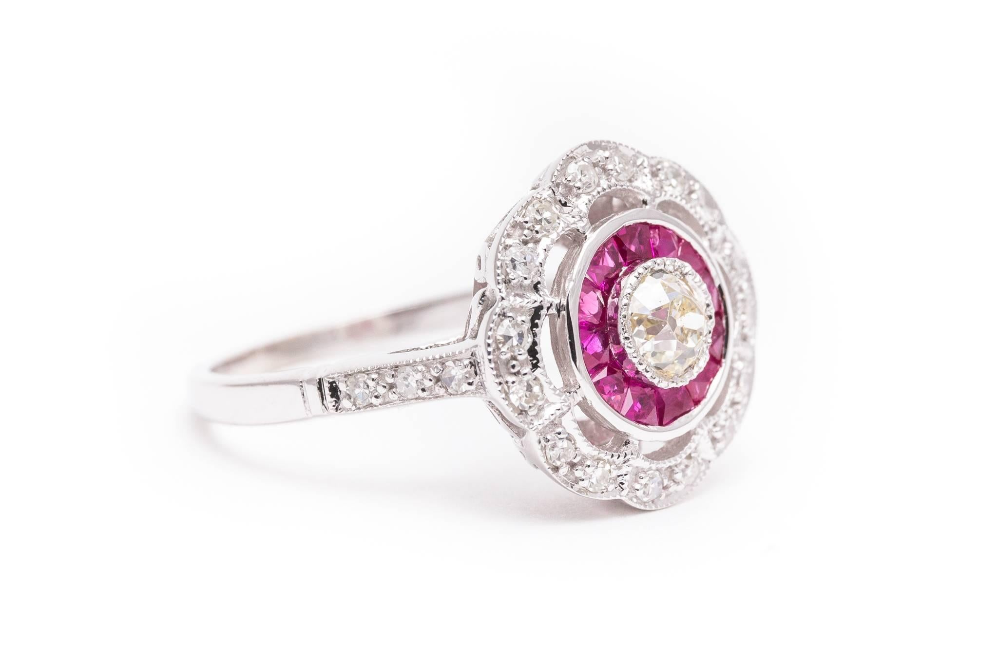 Beacon Hill Jewelers Presents:

A gorgeous target diamond and ruby ring in 14 karat white gold. Centered by an old European cut diamond set in a mille grained bezel, this ring features French cut rubies and diamonds encircling the center