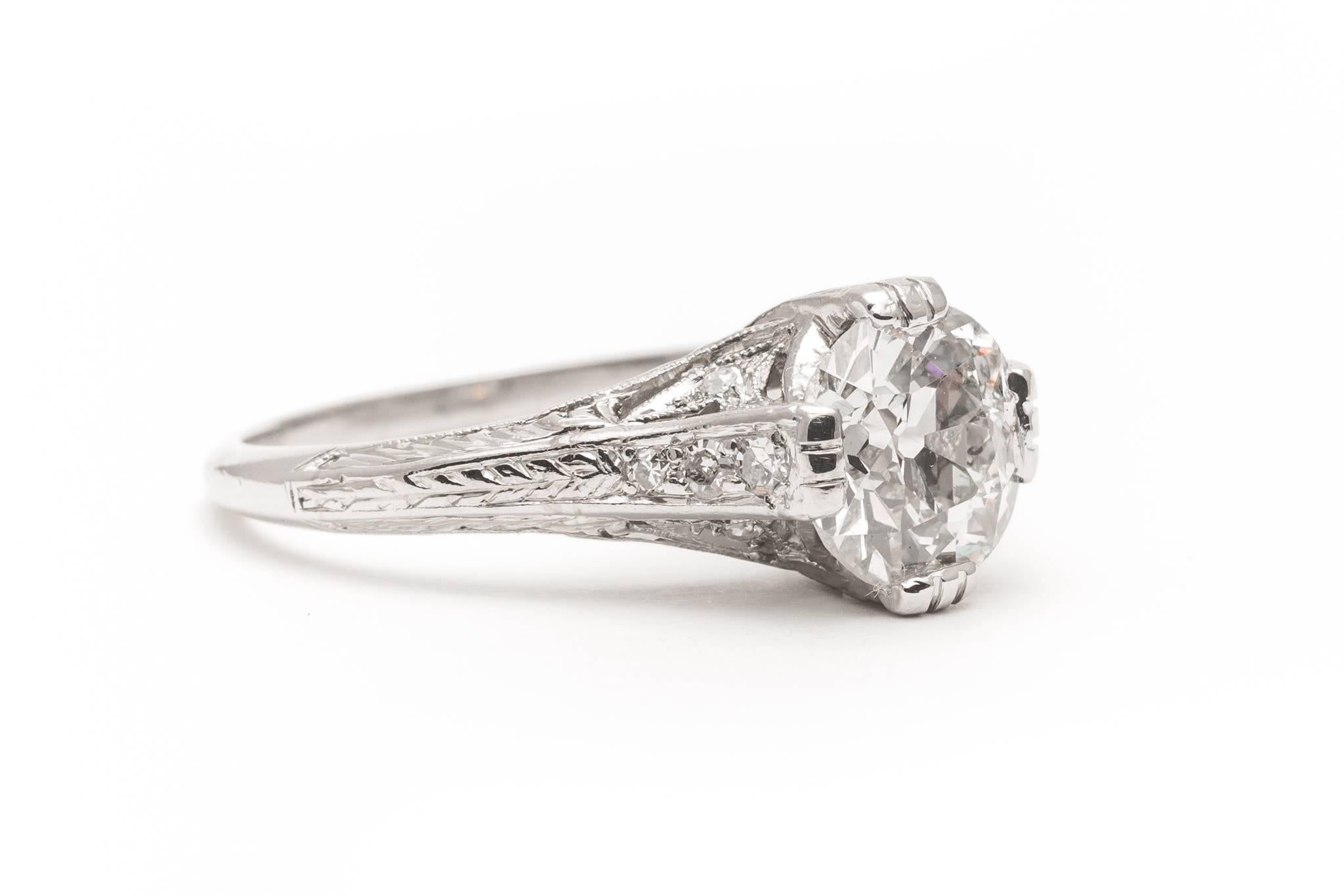 A beautiful original art deco period diamond engagement ring set in luxurious platinum.  Centered by a beautiful antique European cut diamond this ring features a fantastic hand engraved floral mounting in luxurious platinum.

Weighing in at 1.75