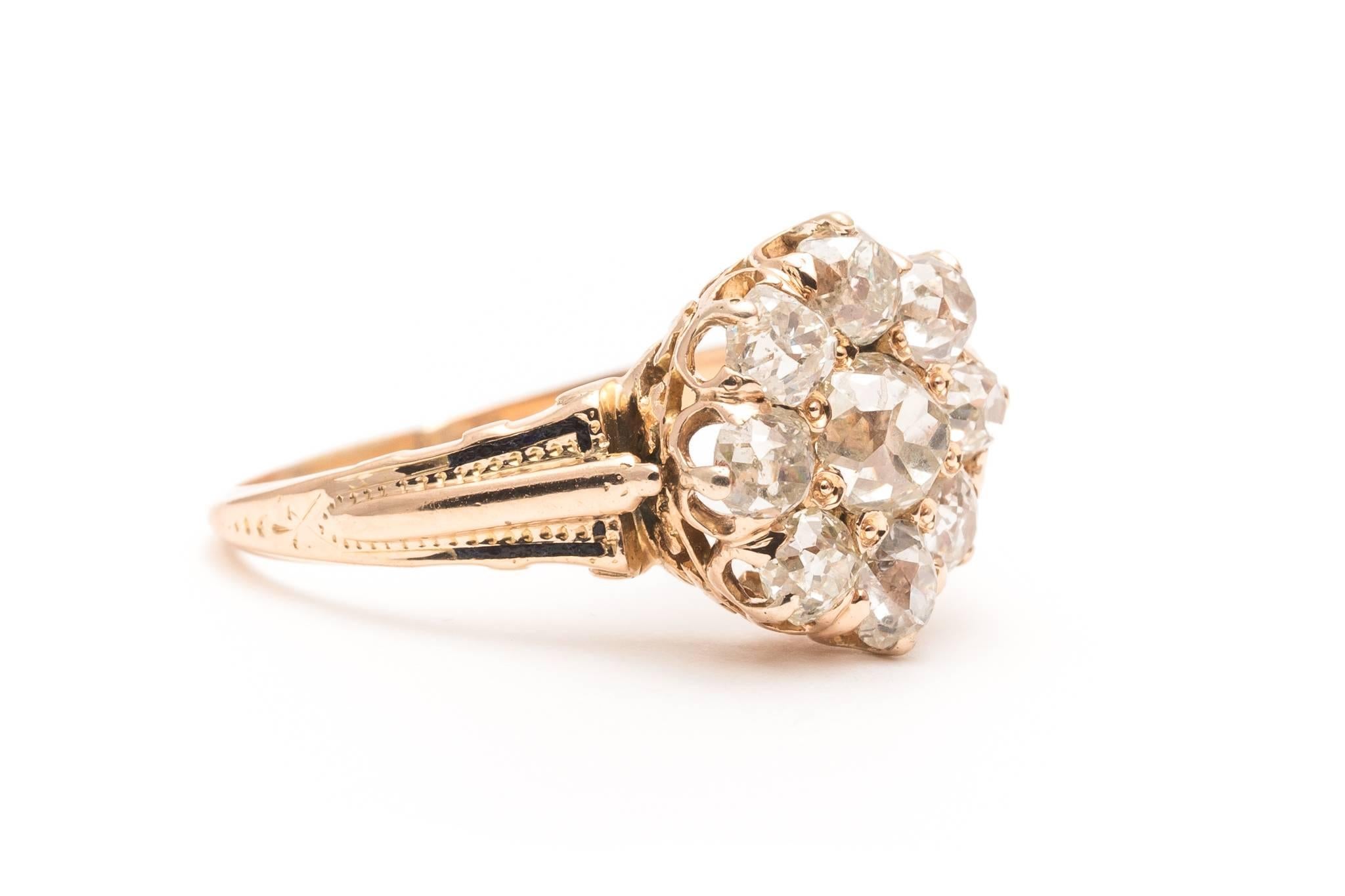 Beacon Hill Jewelers Presents:

An original victorian period diamond cluster style engagement ring in yellow gold.  Featuring a total of nine antique mine cut diamonds this ring is a great example of an original late 19th century diamond engagement