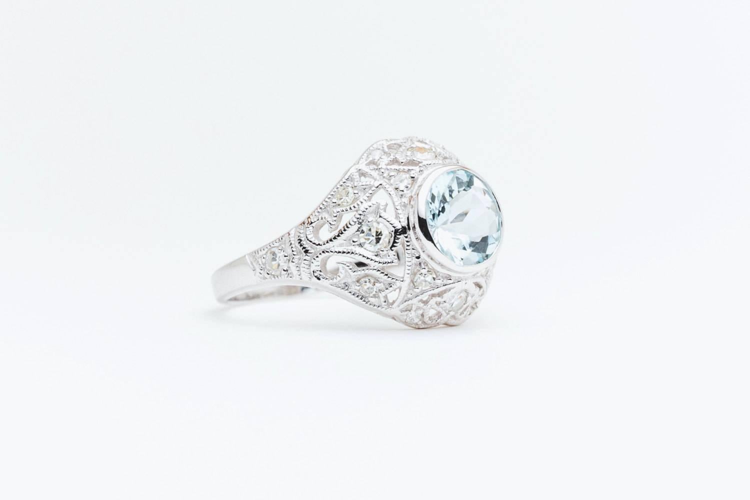 Beacon Hill Jewelers Presents:

A beautiful aquamarine and diamond ring in 14 karat white gold. Featuring eighteen pave set diamonds amidst hand applied mille grain beading, this ring is a beautiful hand crafted piece.

Weighing 1.25 carats, the