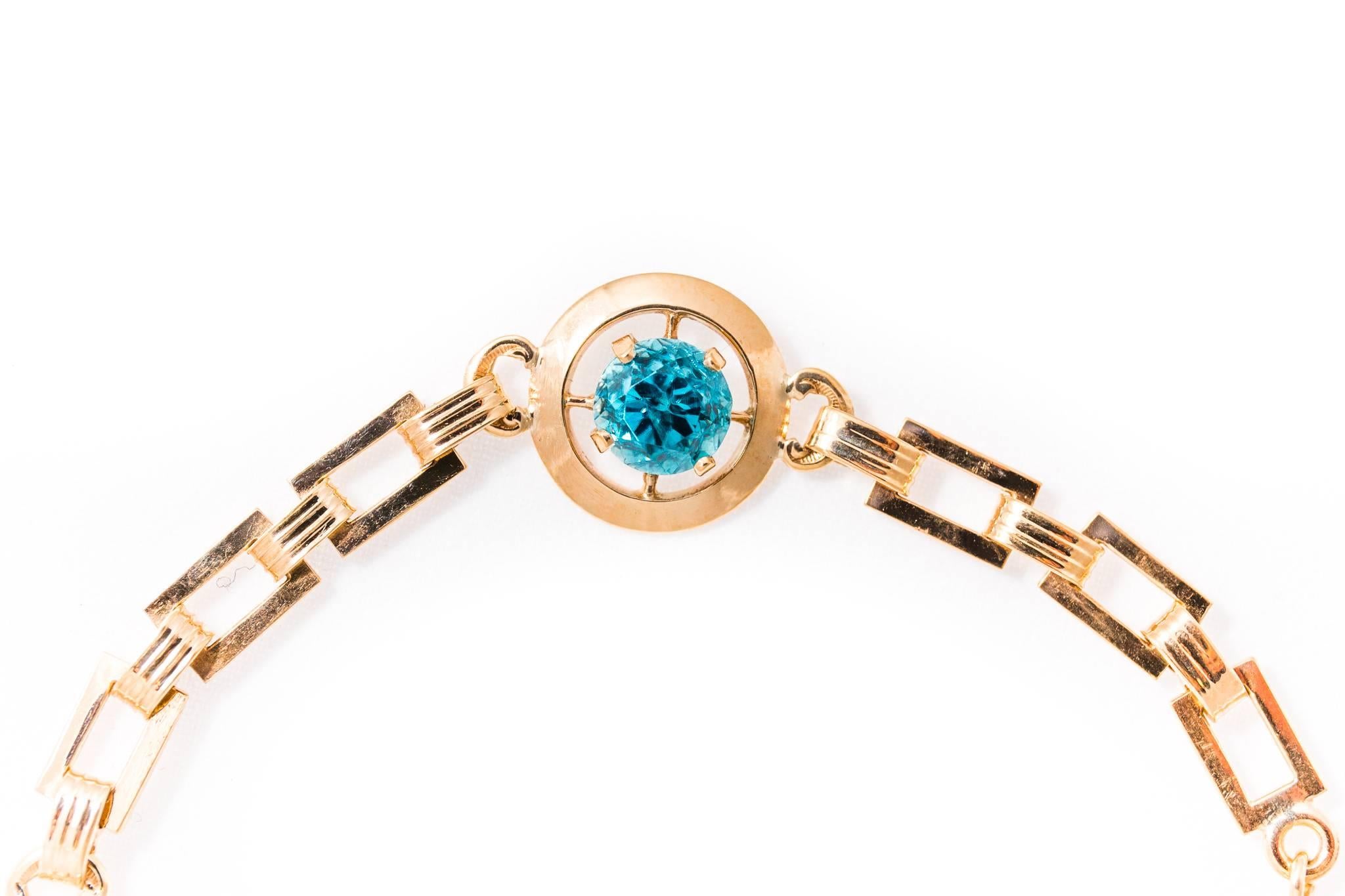 Beacon Hill Jewelers Presents:

A vintage retro period mid century blue zircon bracelet in 14 karat yellow gold.  Set with a trio of high quality rich vivid blue VS clarity blue zircons, this bracelet is a classic mid century piece of American