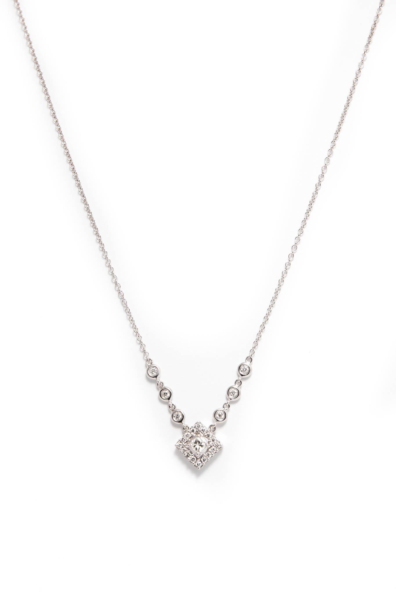 Beacon Hill Jewelers Presents:

A chic contemporary diamond pendant necklace in 18 karat white gold.  Centered by a princess cut 0.25 carat diamond framed by pave set brilliant cut diamonds, this necklace also features size bezel set brilliant cut