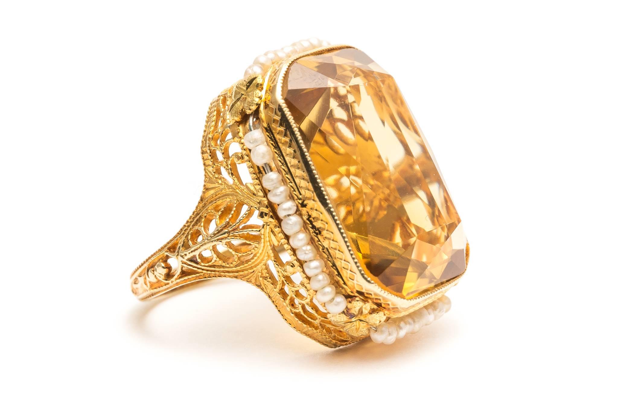 Beacon Hill Jewelers Presents:

A beautiful original art deco period citrine, and pearl ring in 14 karat yellow gold.  Set with an approximately 16 carat rectangular cut citrine, this ring boasts a halo of movable pearl surrounding the citrine along