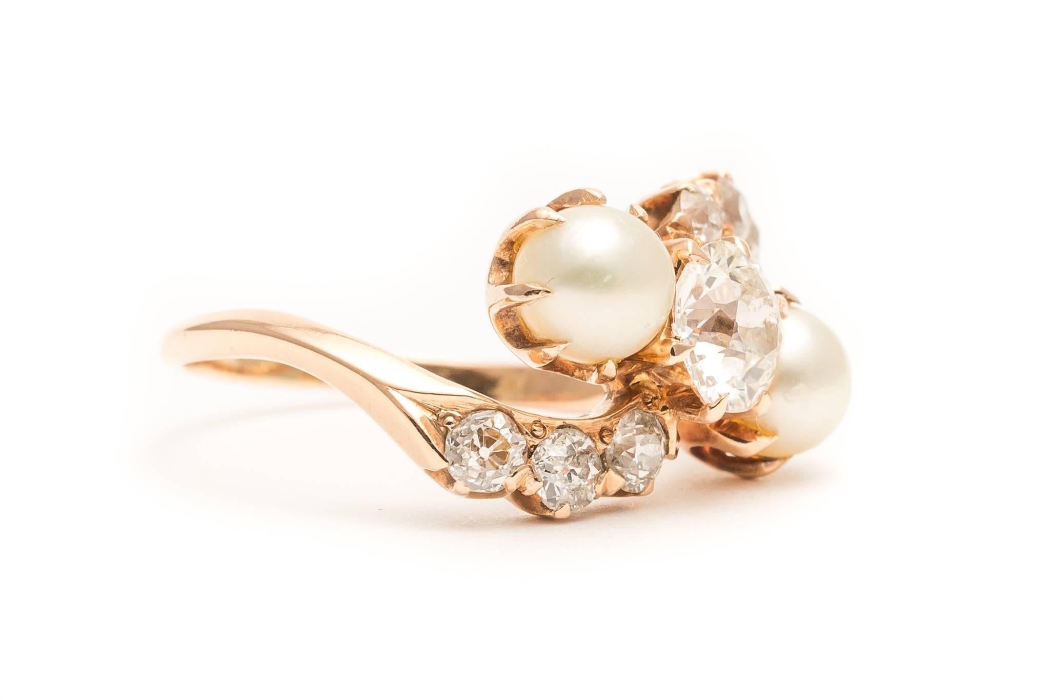 Beacon Hill Jewelers Presents:

A truly entrancing European cut diamond and pearl ring in rich yellow gold.  When we first acquired this ring, I must admit that I was a bit entranced by it.  The pinwheel like design with center diamond as center of