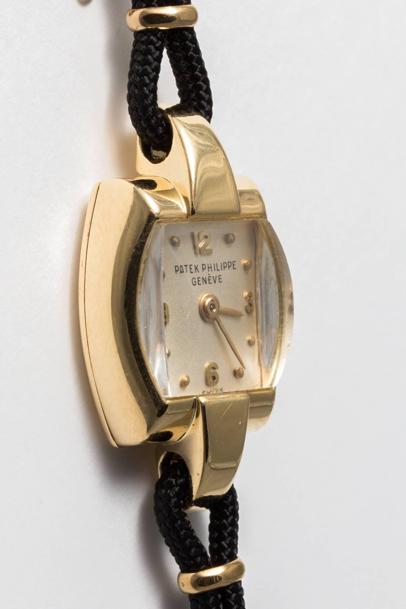 Beacon Hill Jewelers Presents:

A vintage mid century ladies Patek Philippe wrist watch in 18 karat yellow gold.  Mated to a black silk cord strap, this classic vintage ladies wrist watch is in truly immaculate condition.  Having just been fully