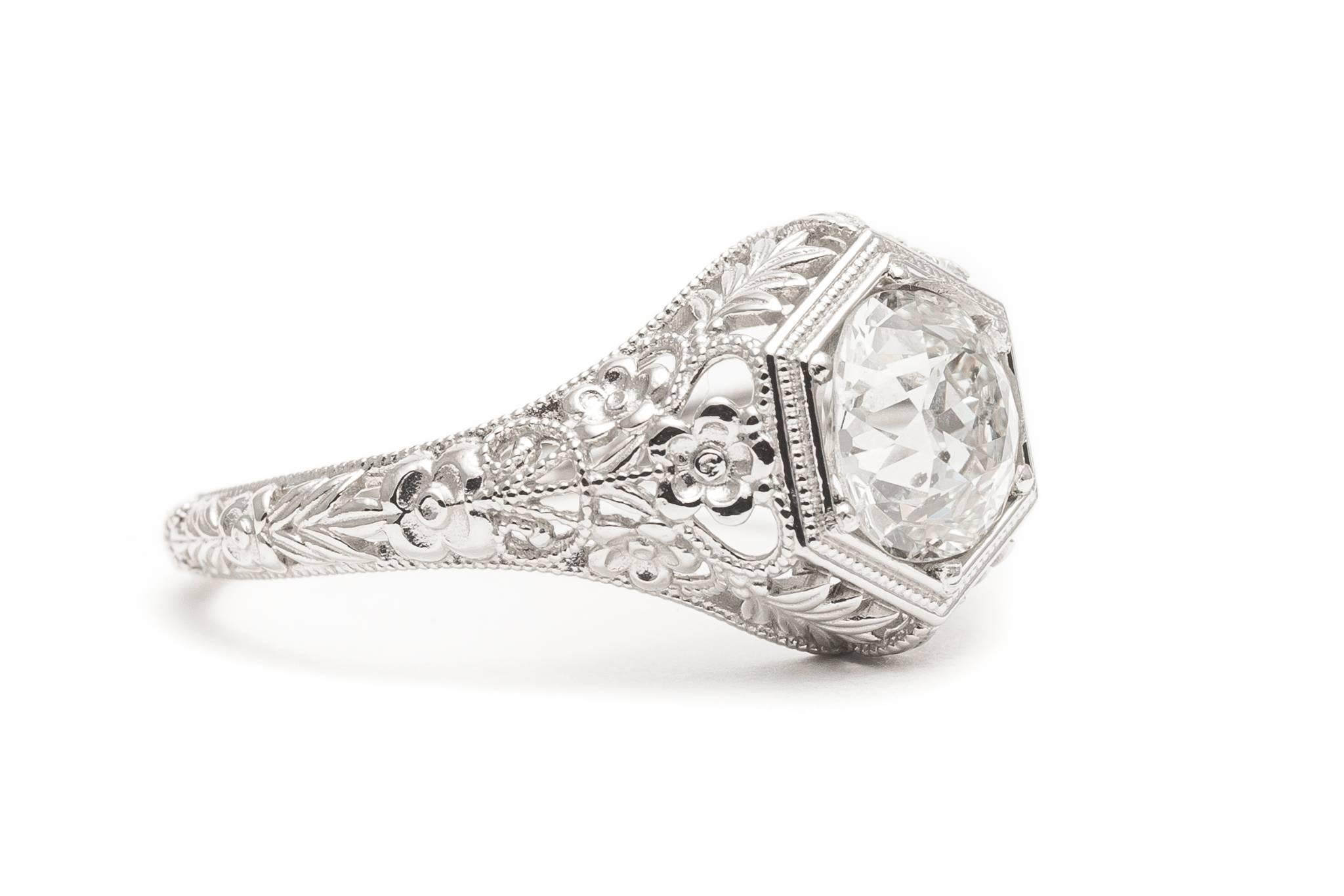 A beautiful handmade diamond filigree engagement ring in luxurious platinum. Centered by an antique European cut diamond, this ring features fantastic high quality floral motif filigree work throughout along with beautiful hand carving.

Grading as