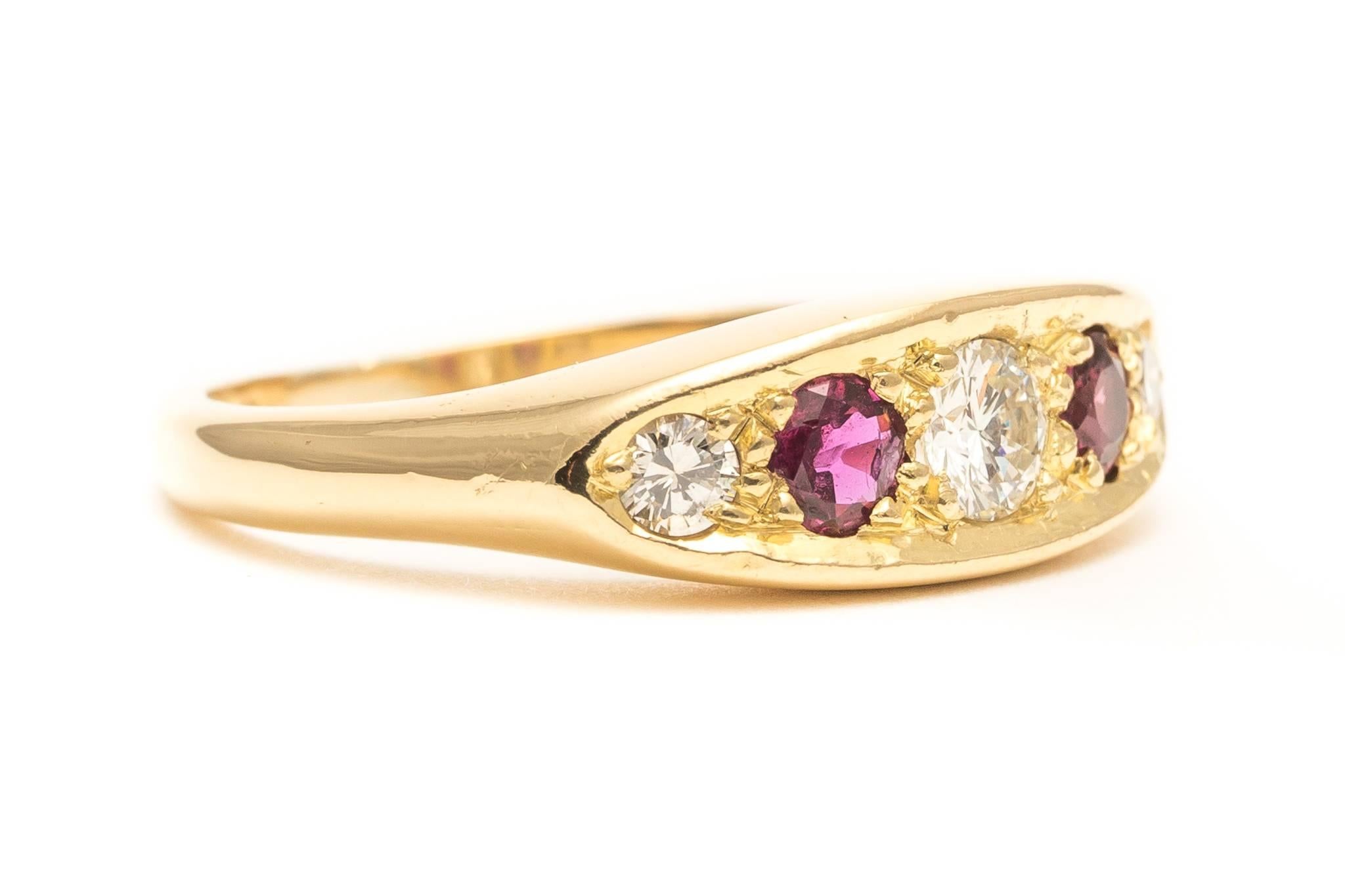 Beacon Hill Jewelers Presents:

A vintage English ruby and diamond band in 18 karat yellow gold. Set with a trio of sparkling bright white diamonds and a pair of rich red rubies, this ring would be excellent as either a wedding band or a right hand