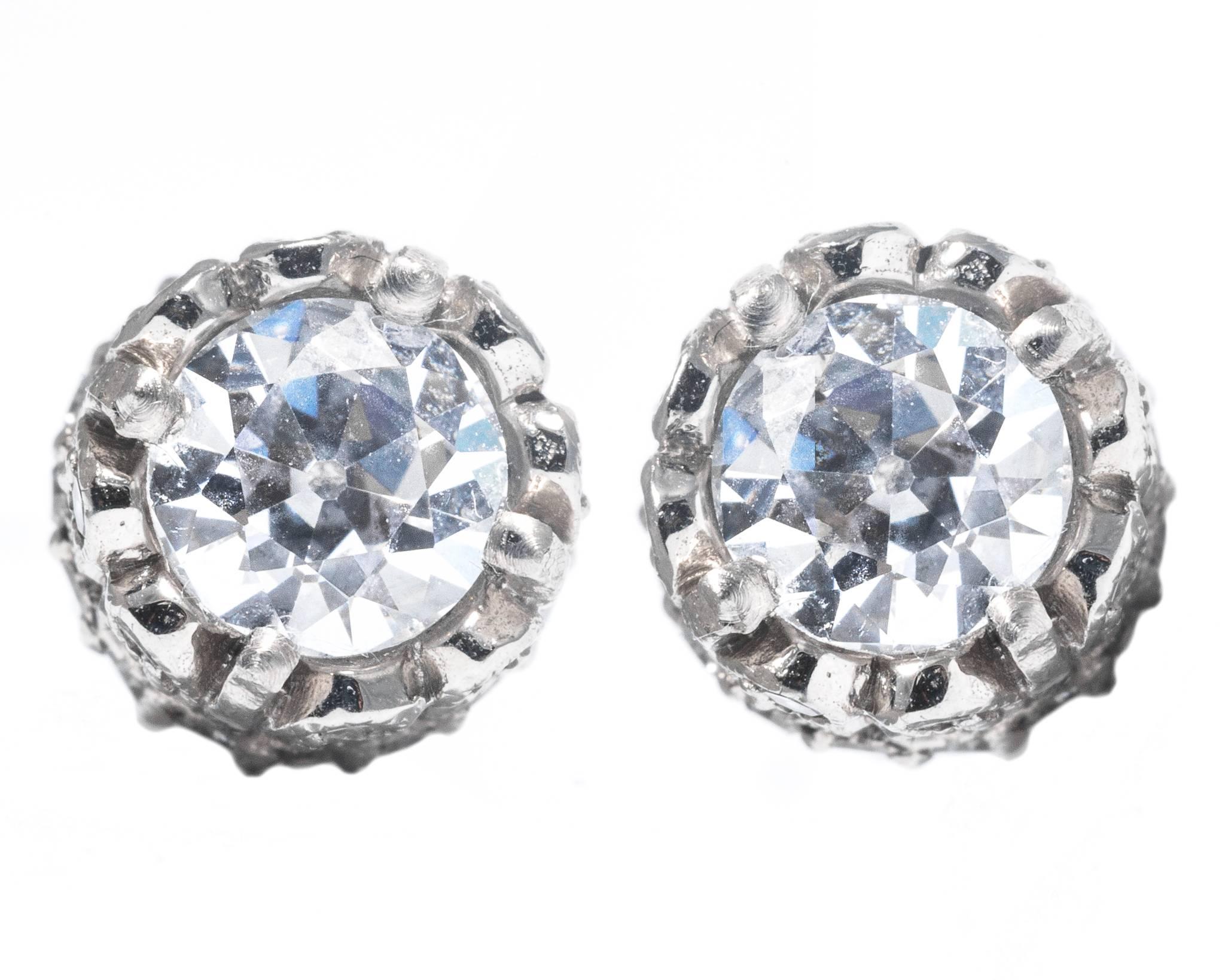 A pair of beautiful pave set diamond stud earrings. Set with a total of sixty two accenting diamonds, and two center European cut diamonds, these earrings offer a fantastic twist on traditional diamond studs.

Grading as superb VS2 clarity and