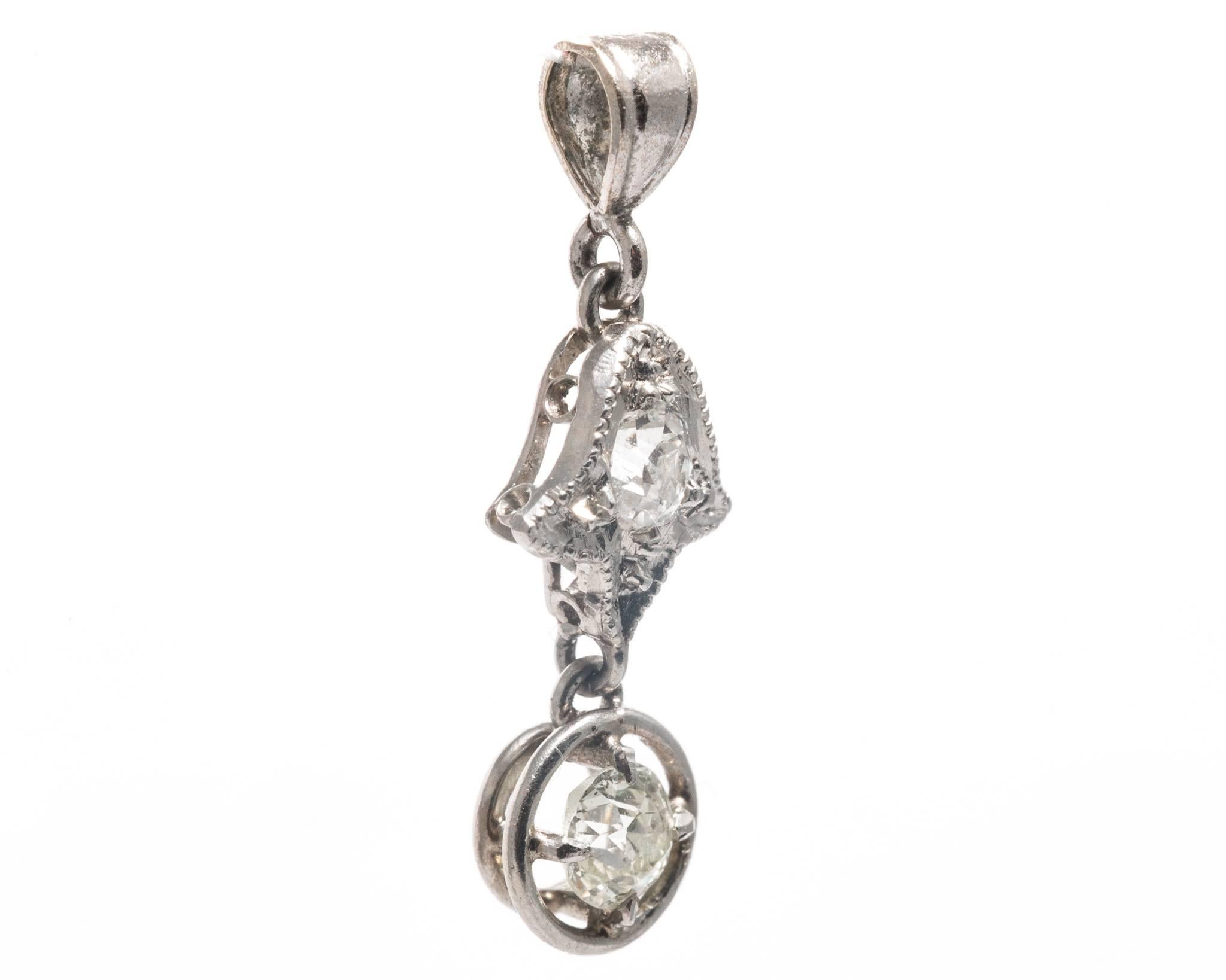 Beacon Hill Jewelers Presents:

An original art deco period diamond pendant necklace in luxurious platinum. Set with a pair of sparkling antique European cut diamonds this pendant is designed as a tulip like flower attached to a dangling
