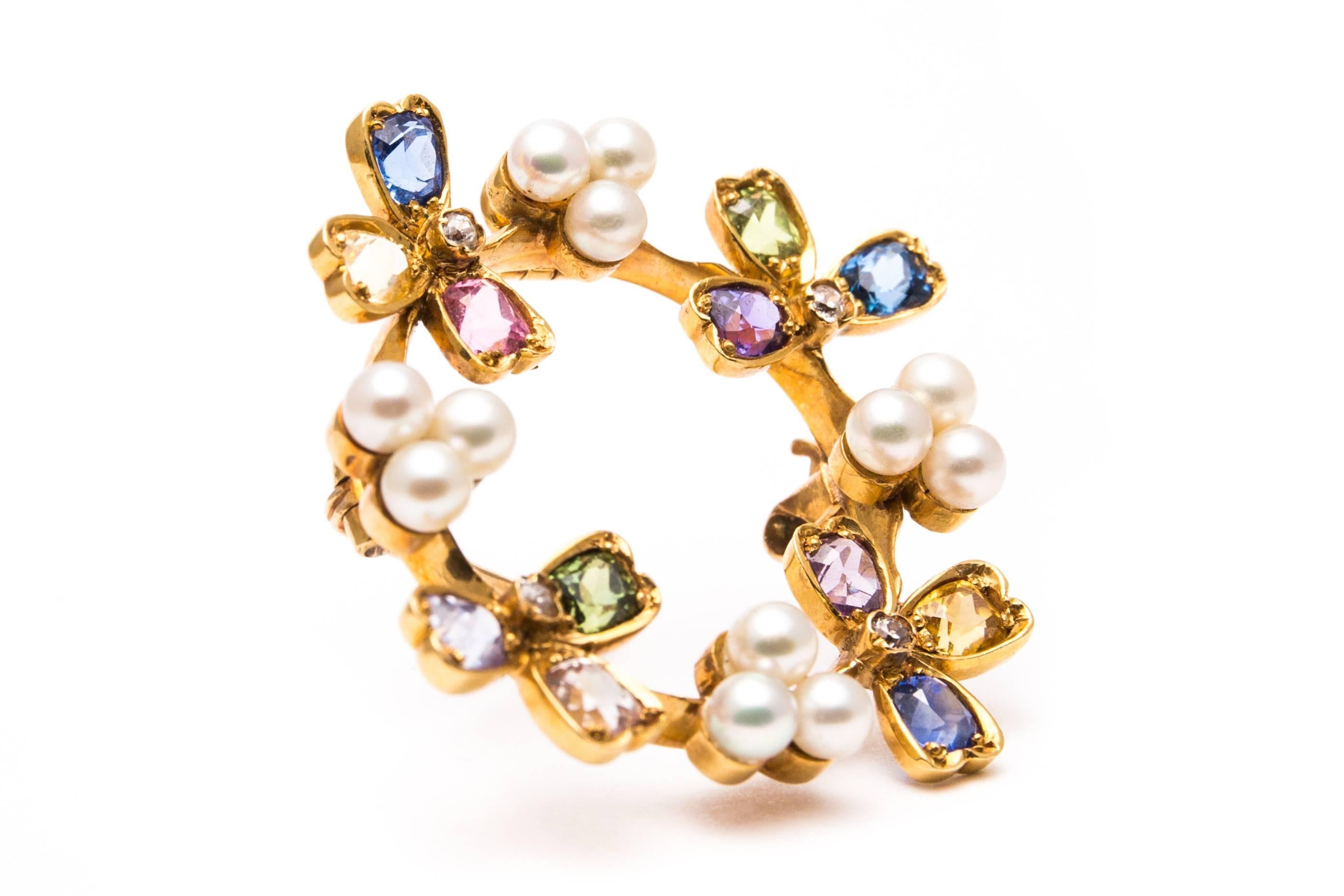 Beacon Hill Jewelers Presents:

An exceptional Tiffany and Company edwardian period pendant brooch.  Designed as a circle of leaves set with multi color sapphires in every color of the rainbow this brooch also features clusters of pearl